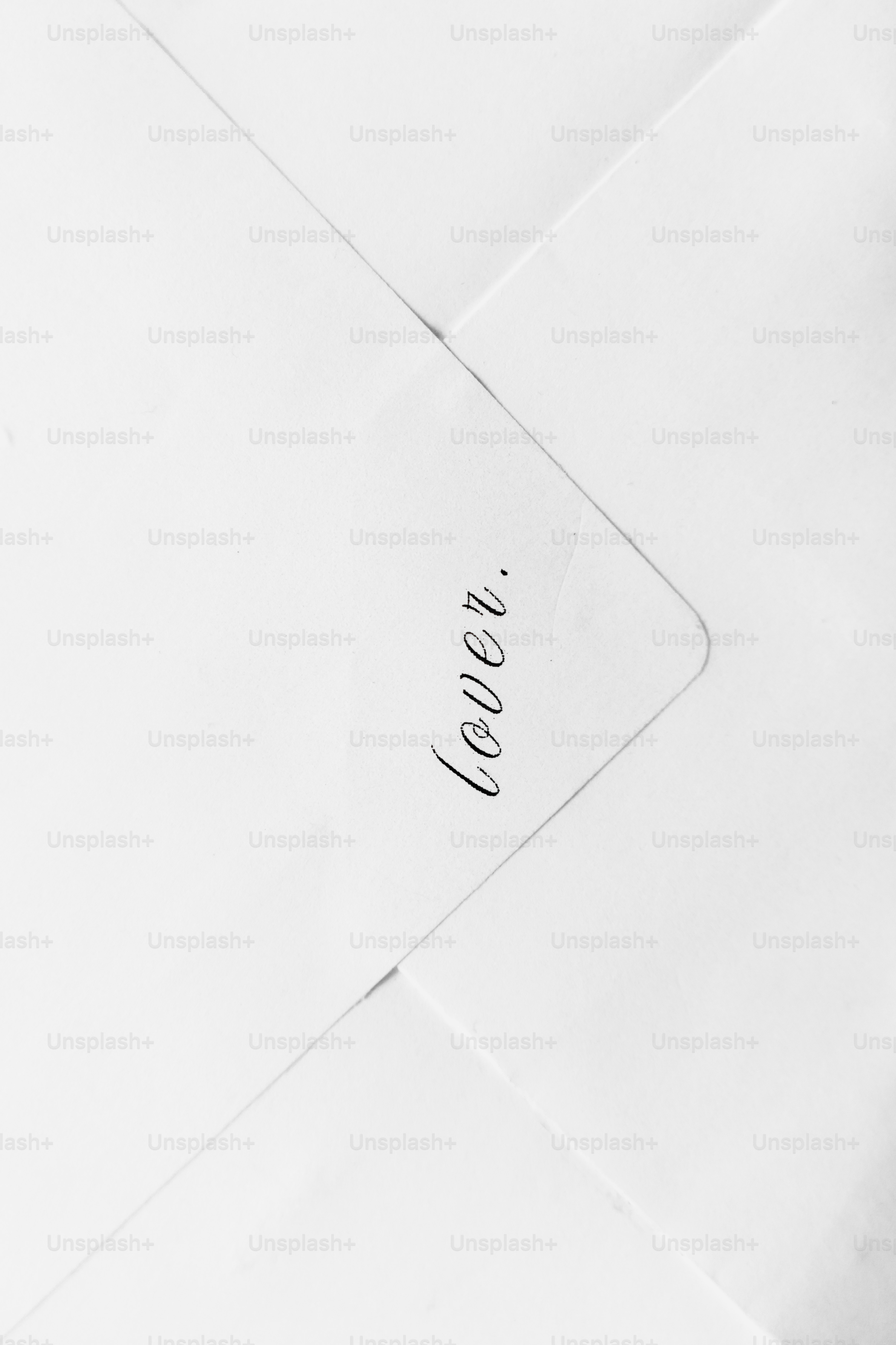 The word "lover" written on white paper.