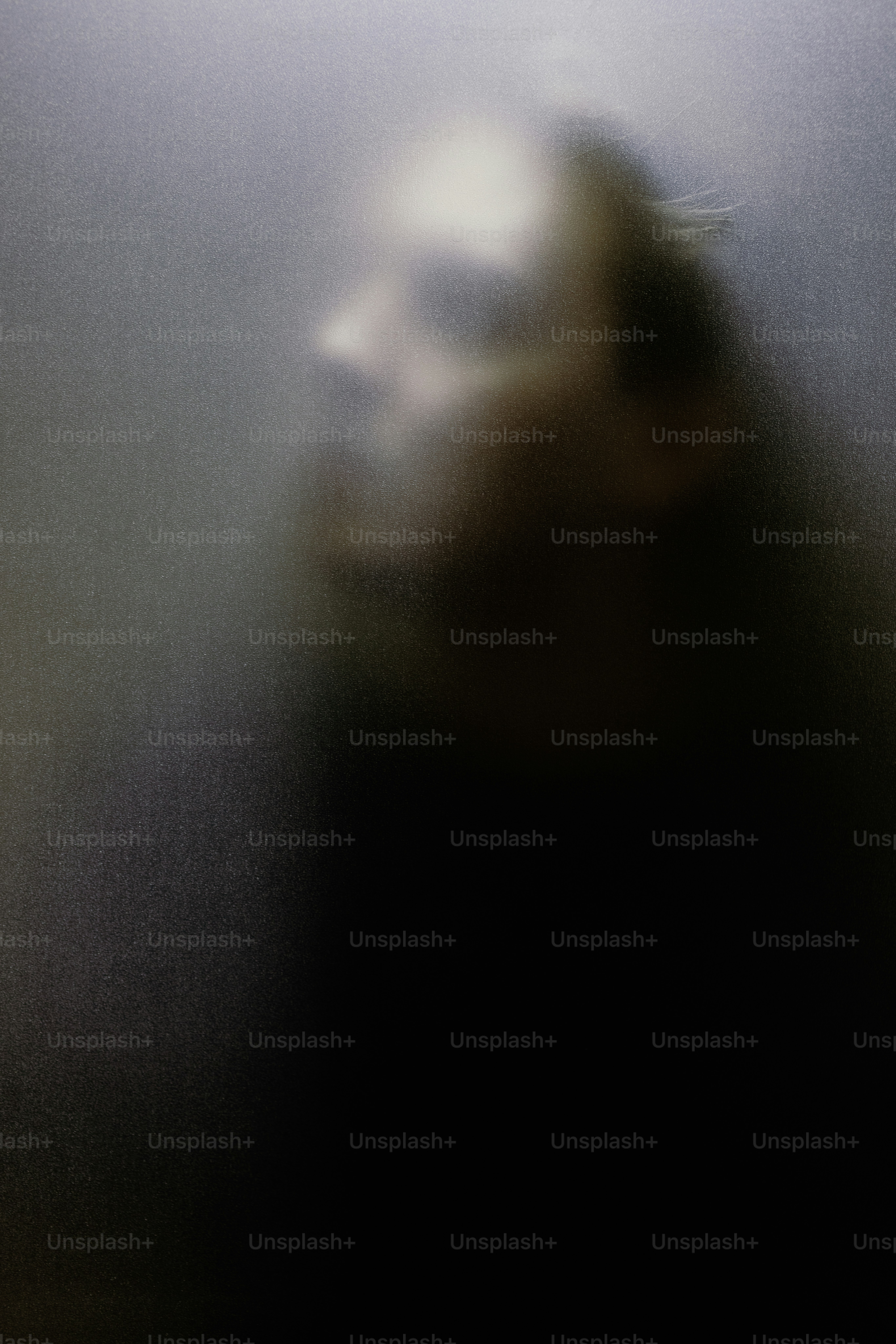 Blurred profile of a person's face in dark