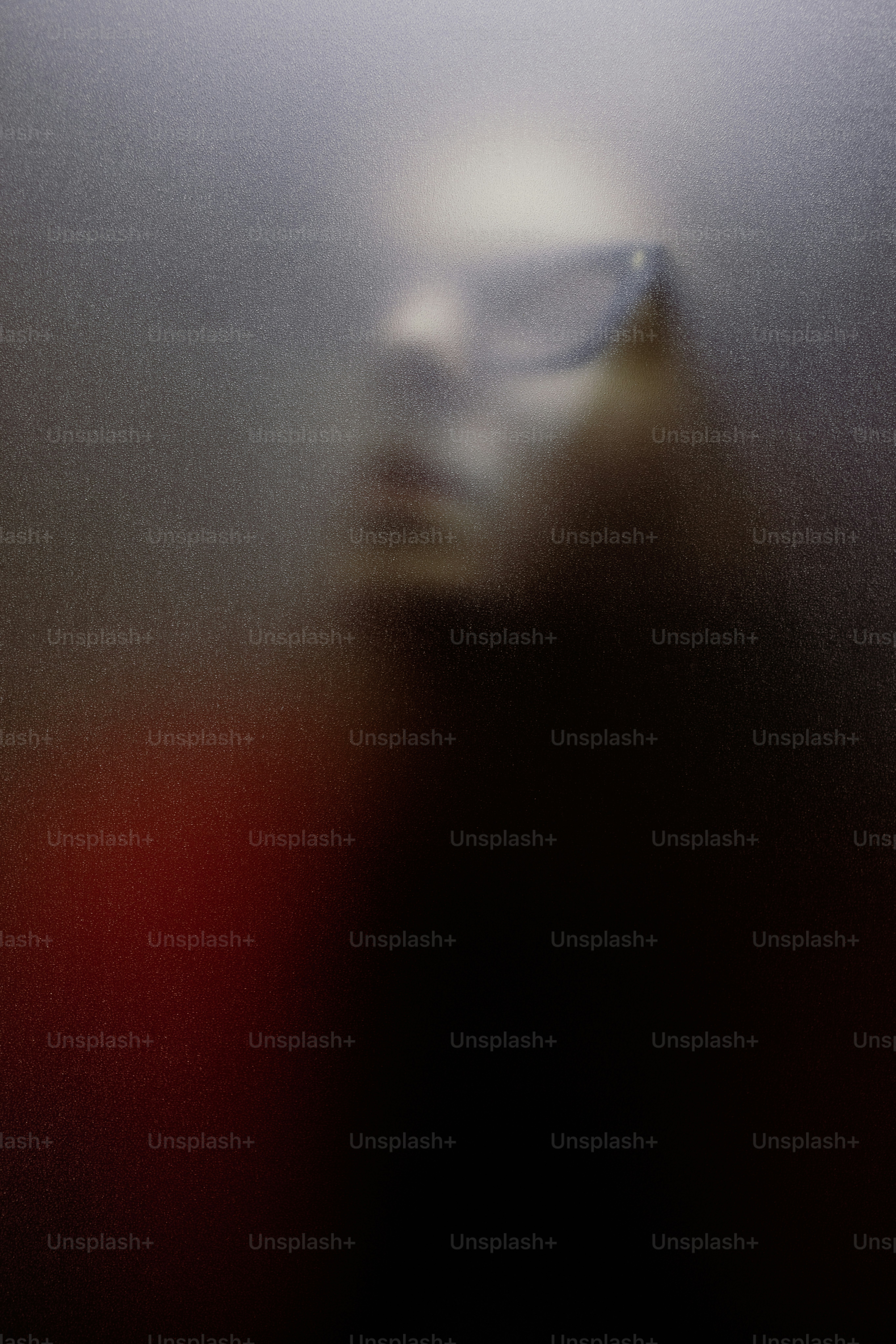 Blurred silhouette of a person wearing sunglasses