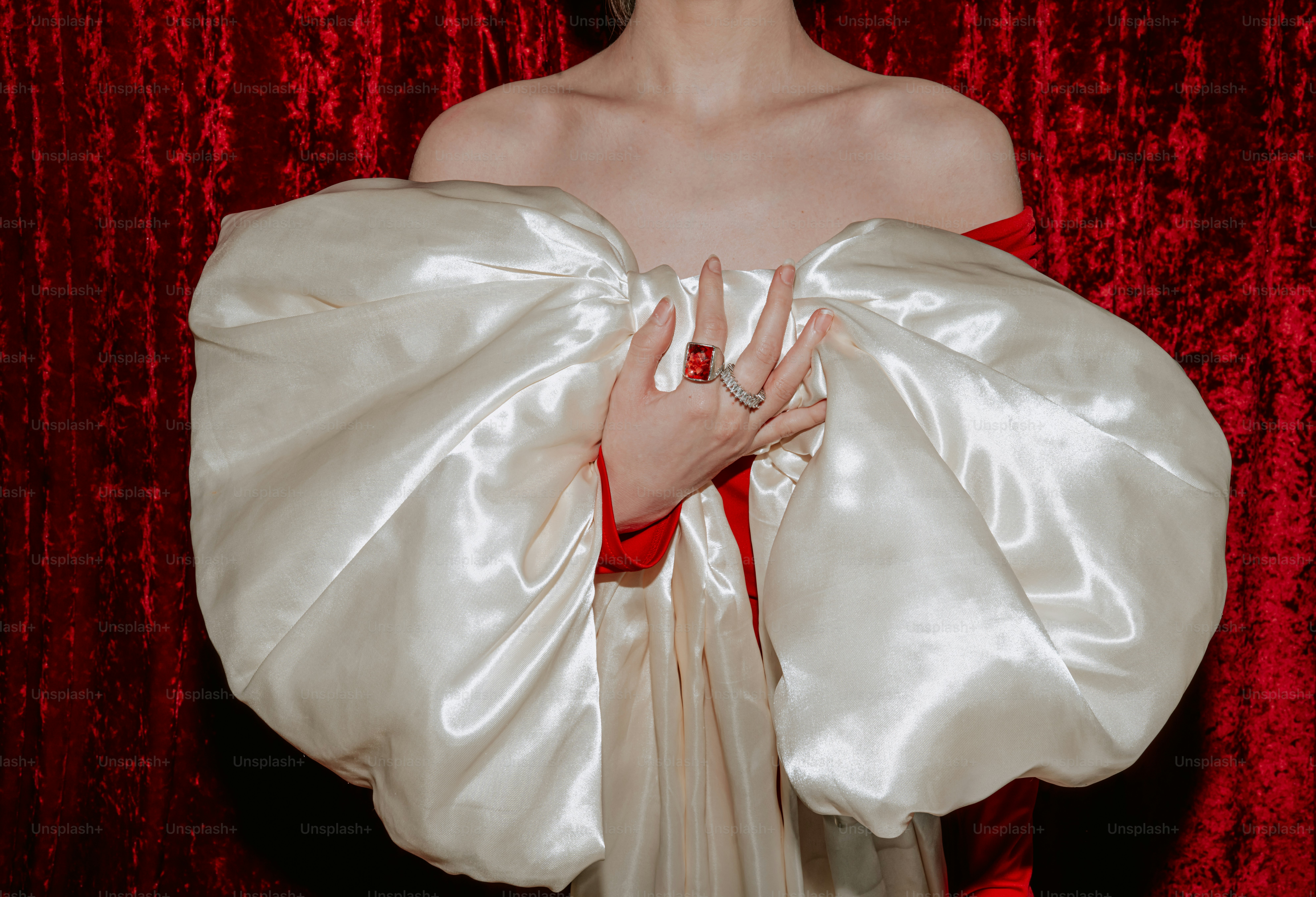 A person in a white dress with large sleeves