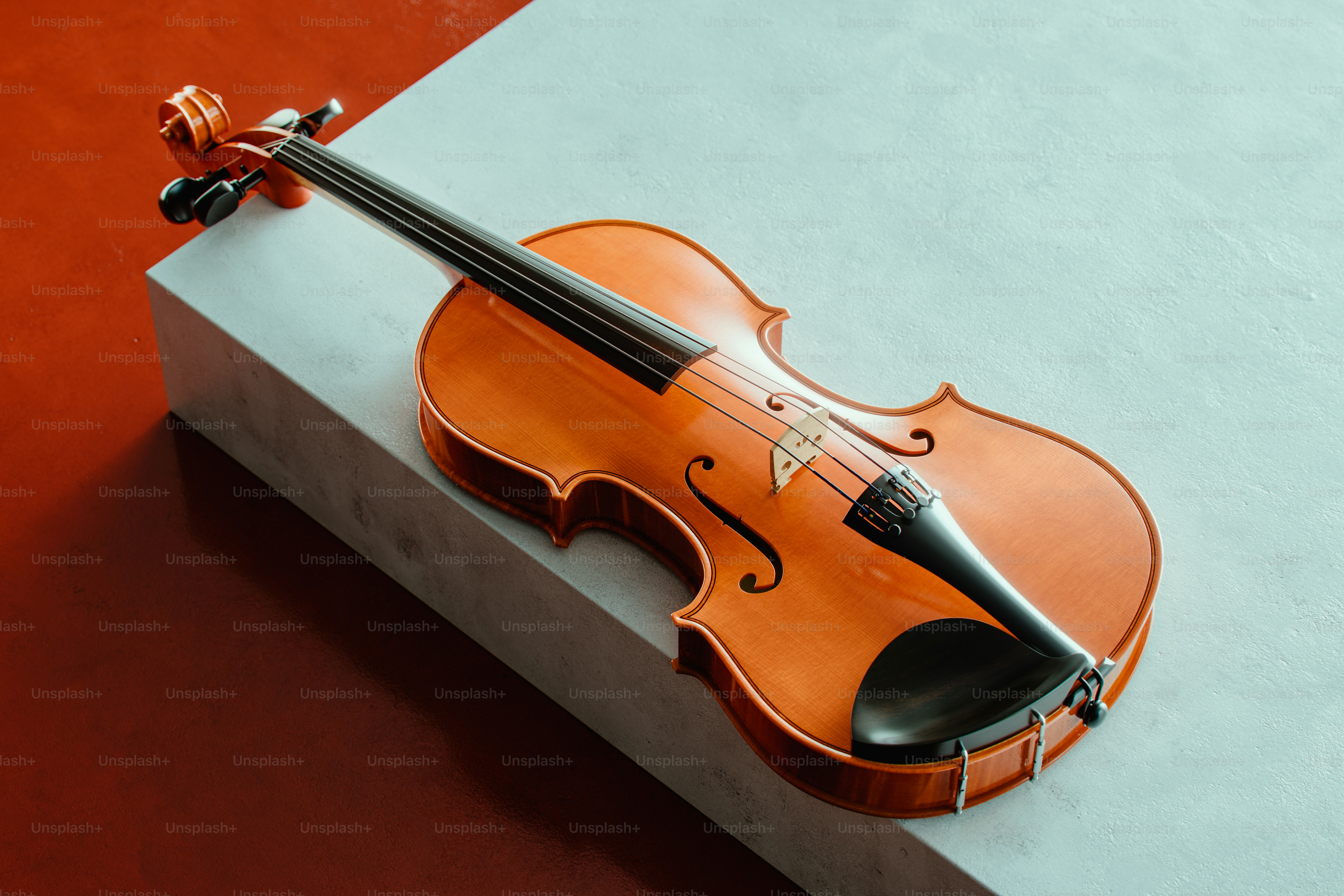 A wooden violin rests on a geometric surface.