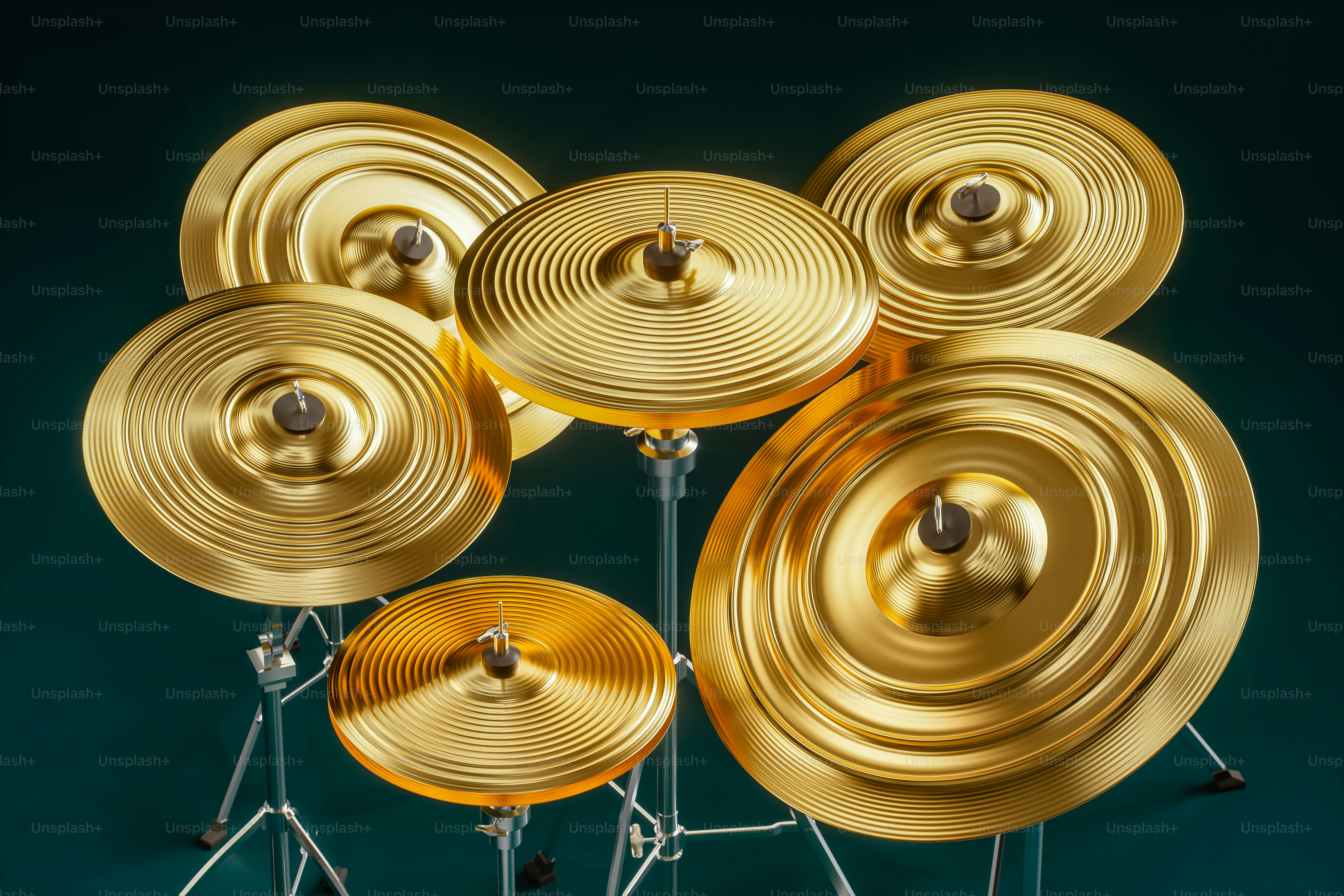 A collection of shiny golden cymbals on stands.