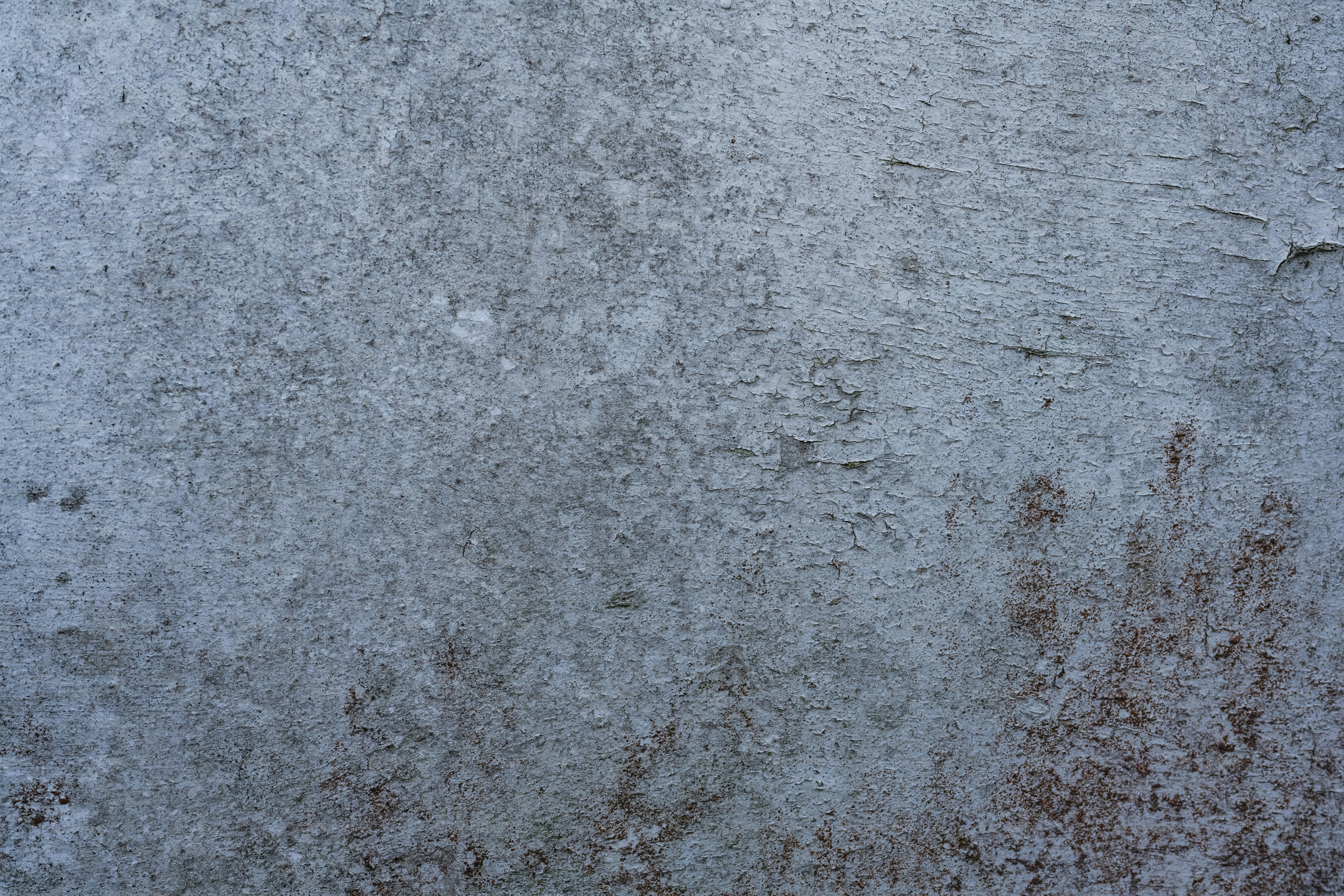 A textured grey and brown concrete wall