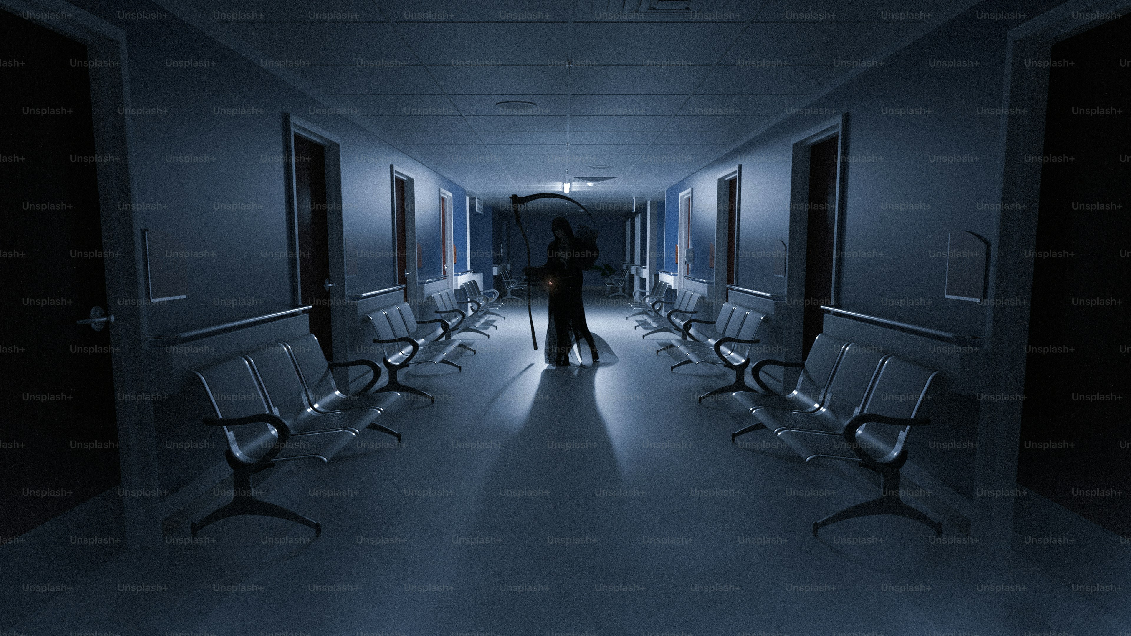Figure in dark hallway with rows of chairs.