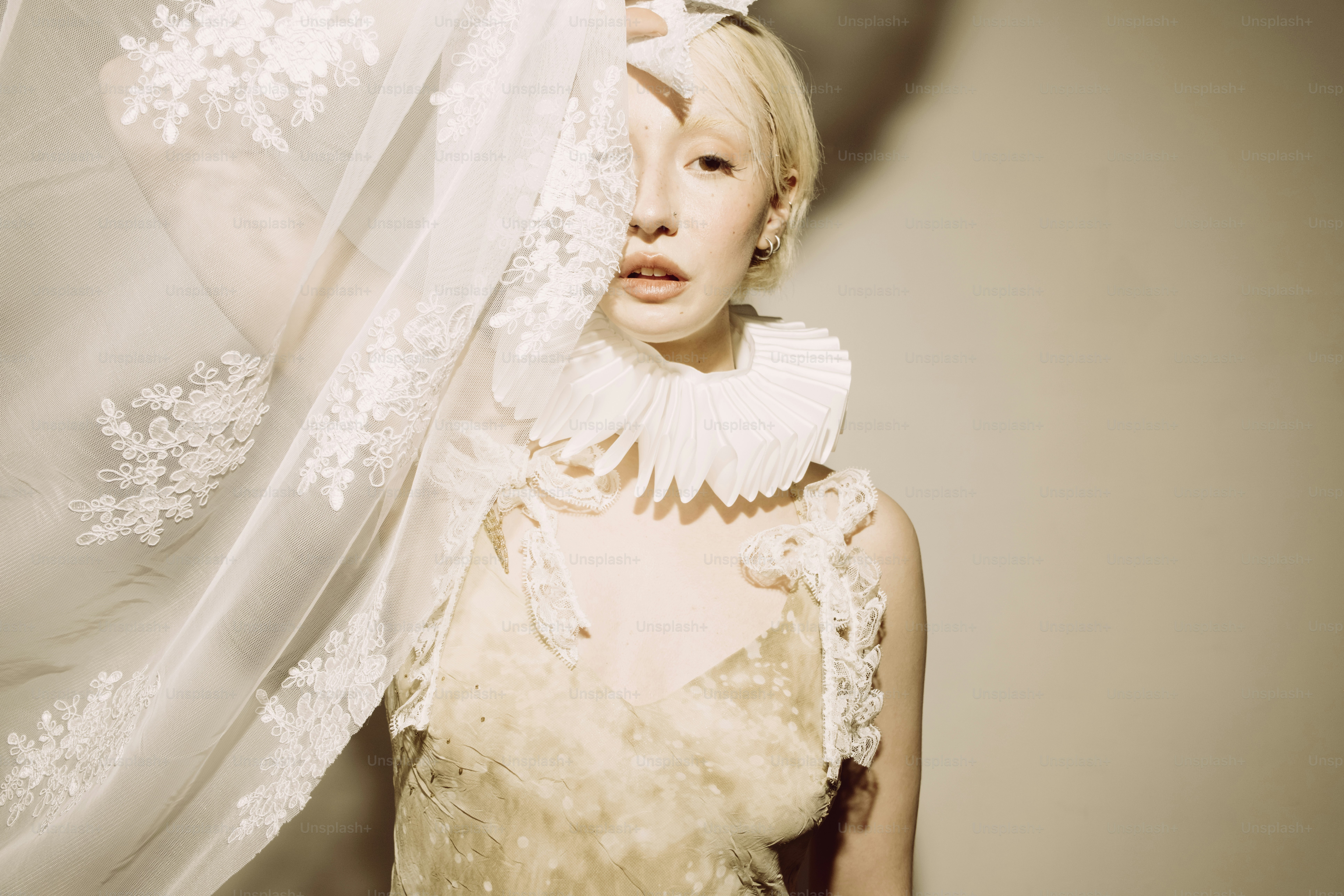 Woman in ornate white dress with lace veil