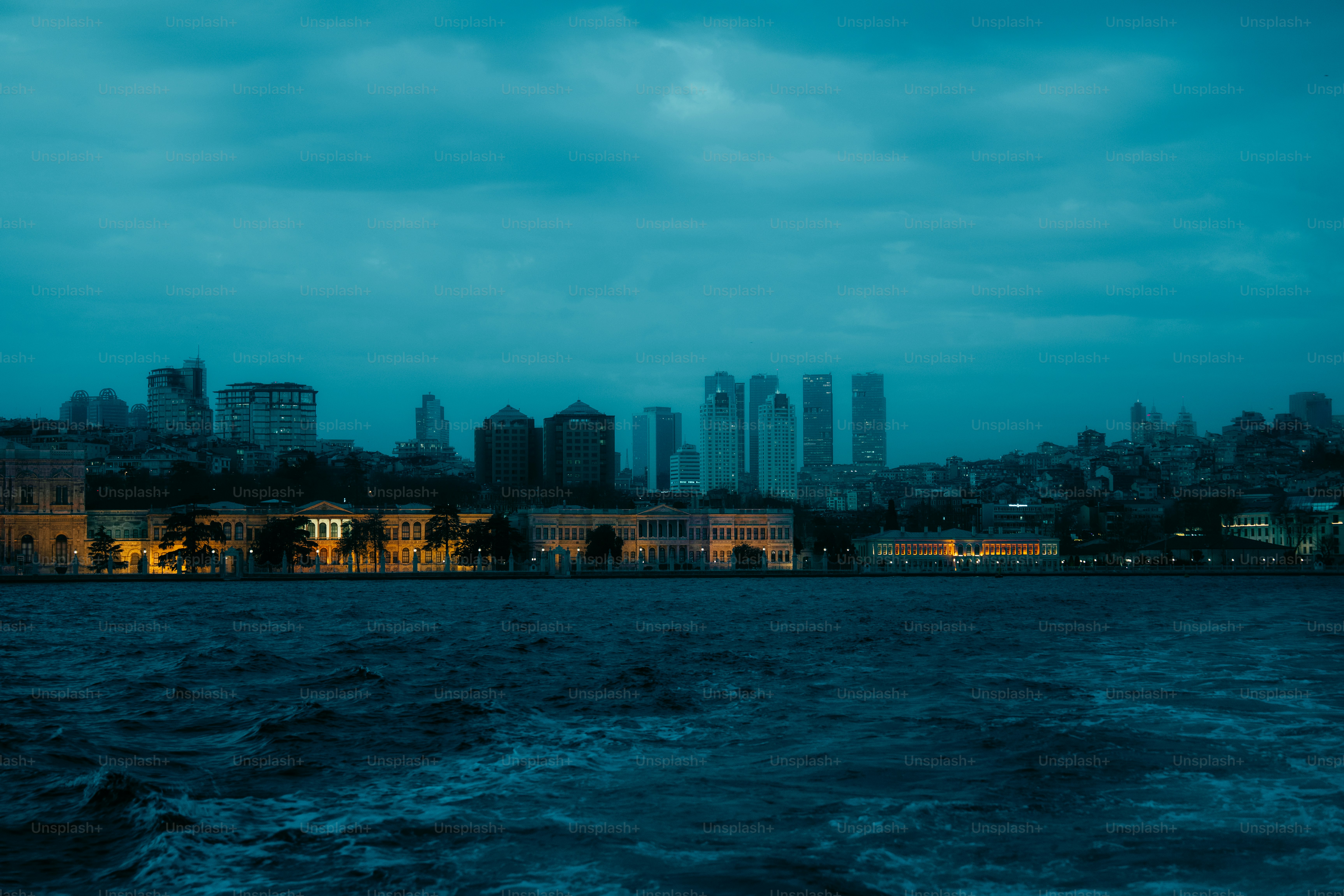 City skyline across the water at dusk photo – Sea Image on Unsplash