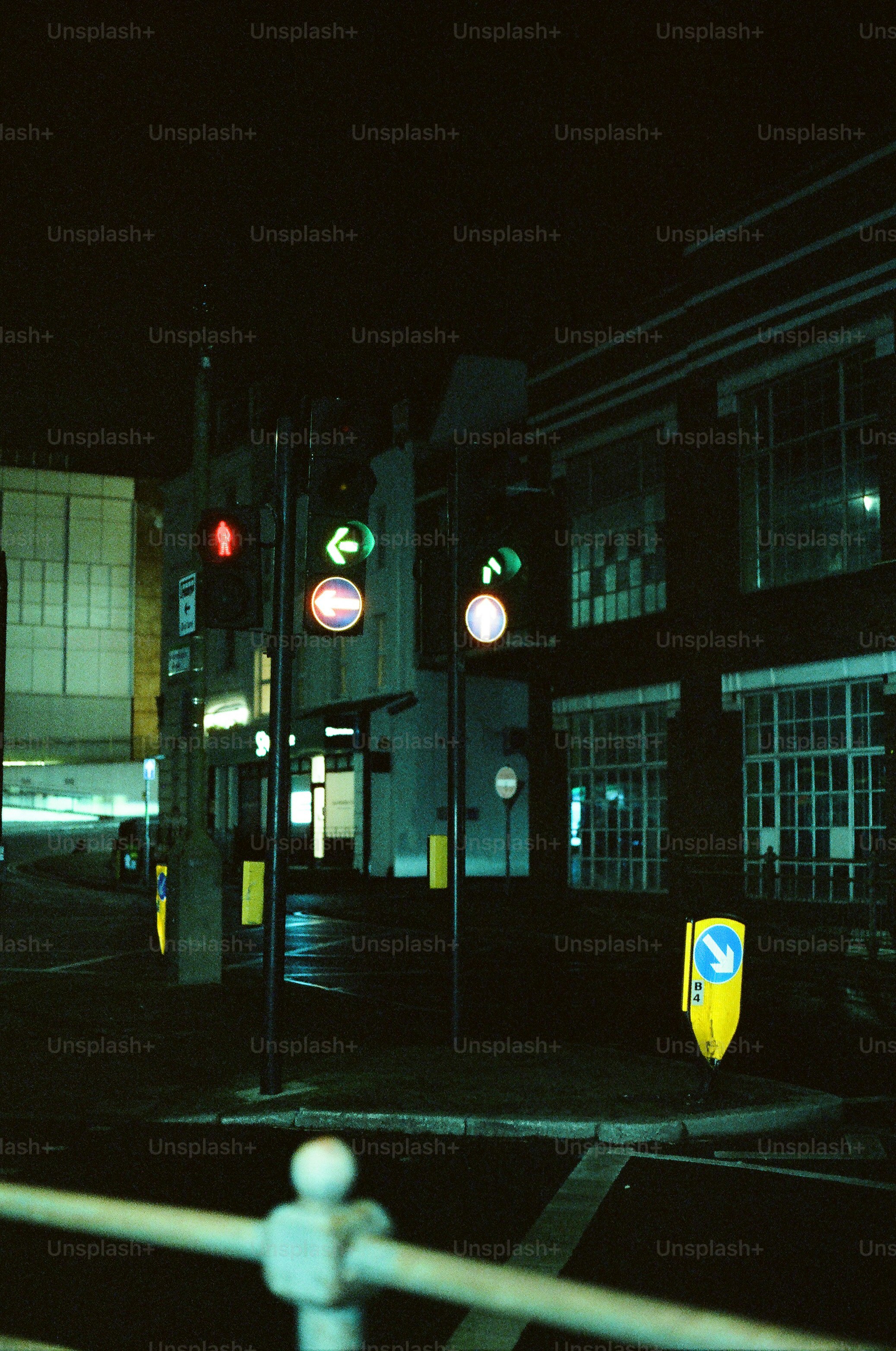 City street with traffic lights at night.