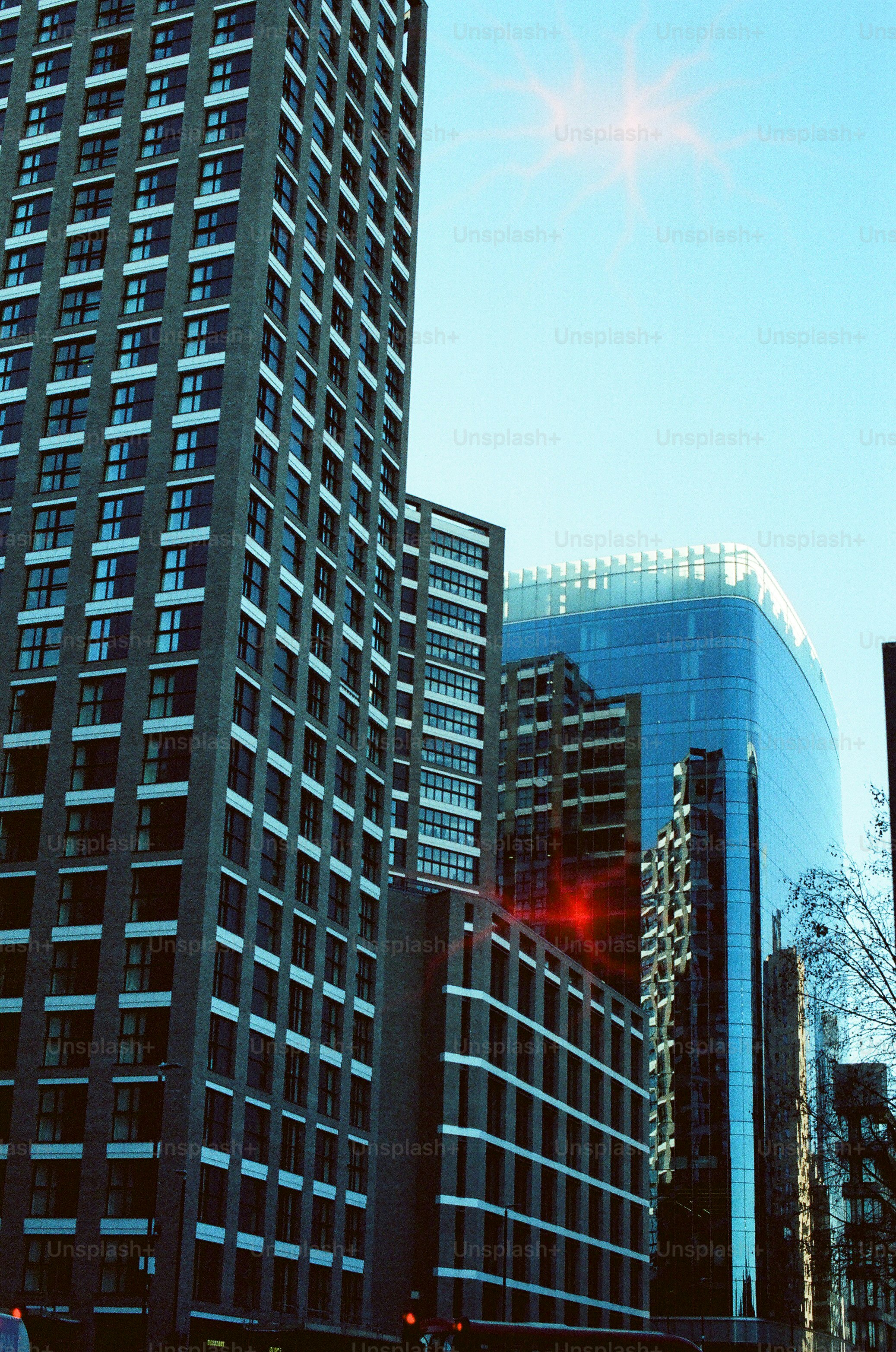 Modern skyscrapers under a clear blue sky.
