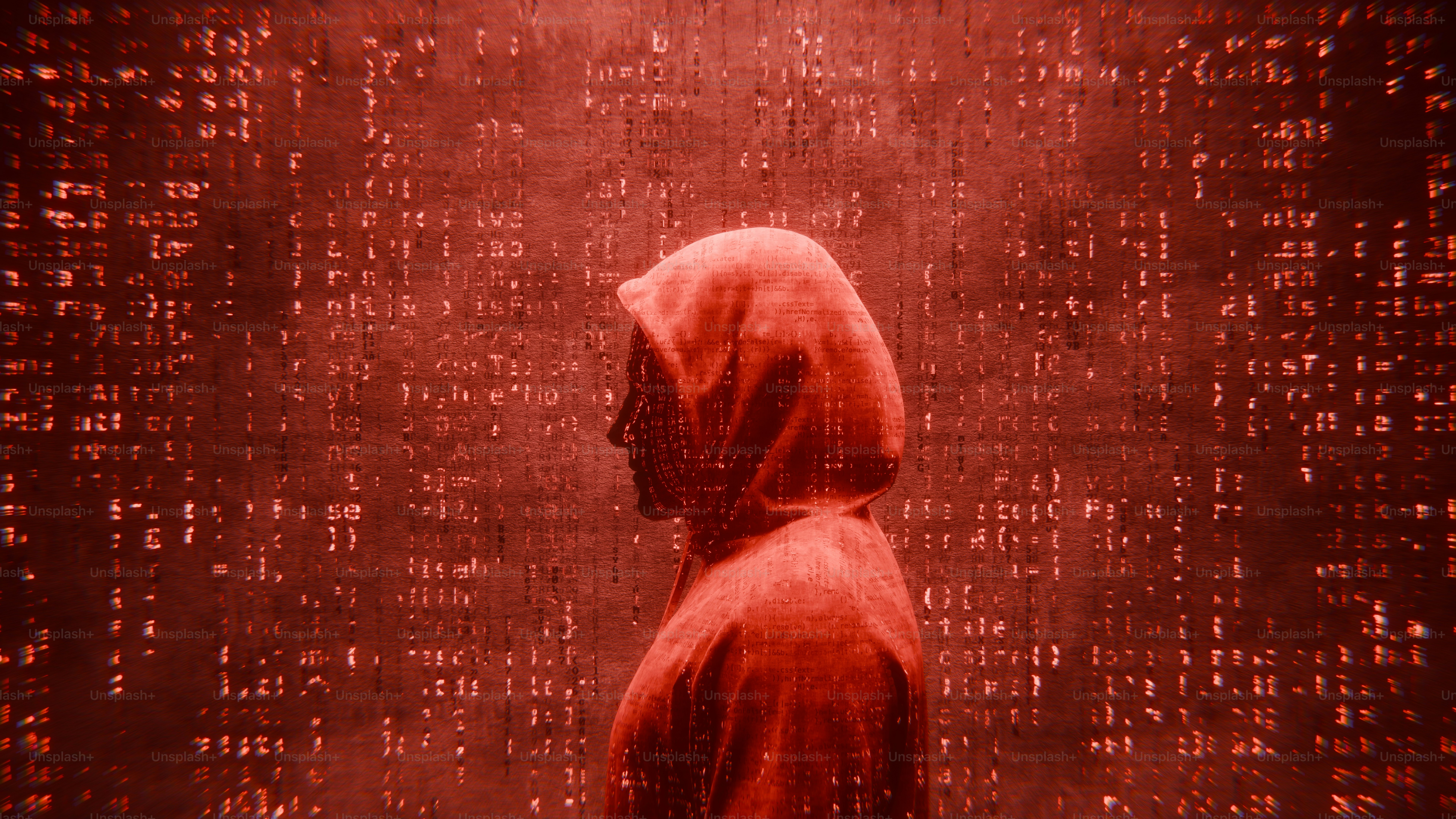 Person in red hoodie stands before red digital matrix