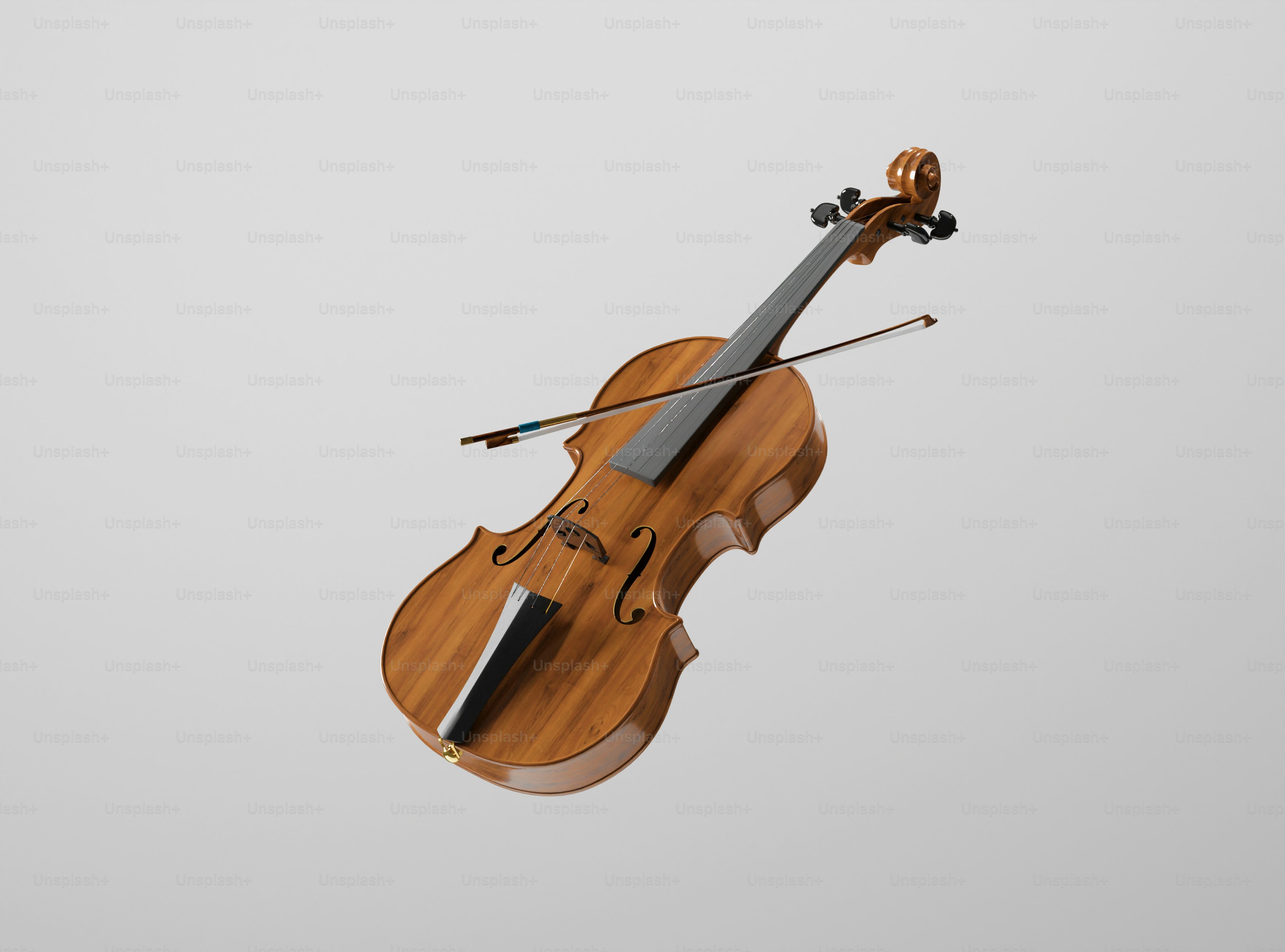 A wooden violin and bow against a gray background.