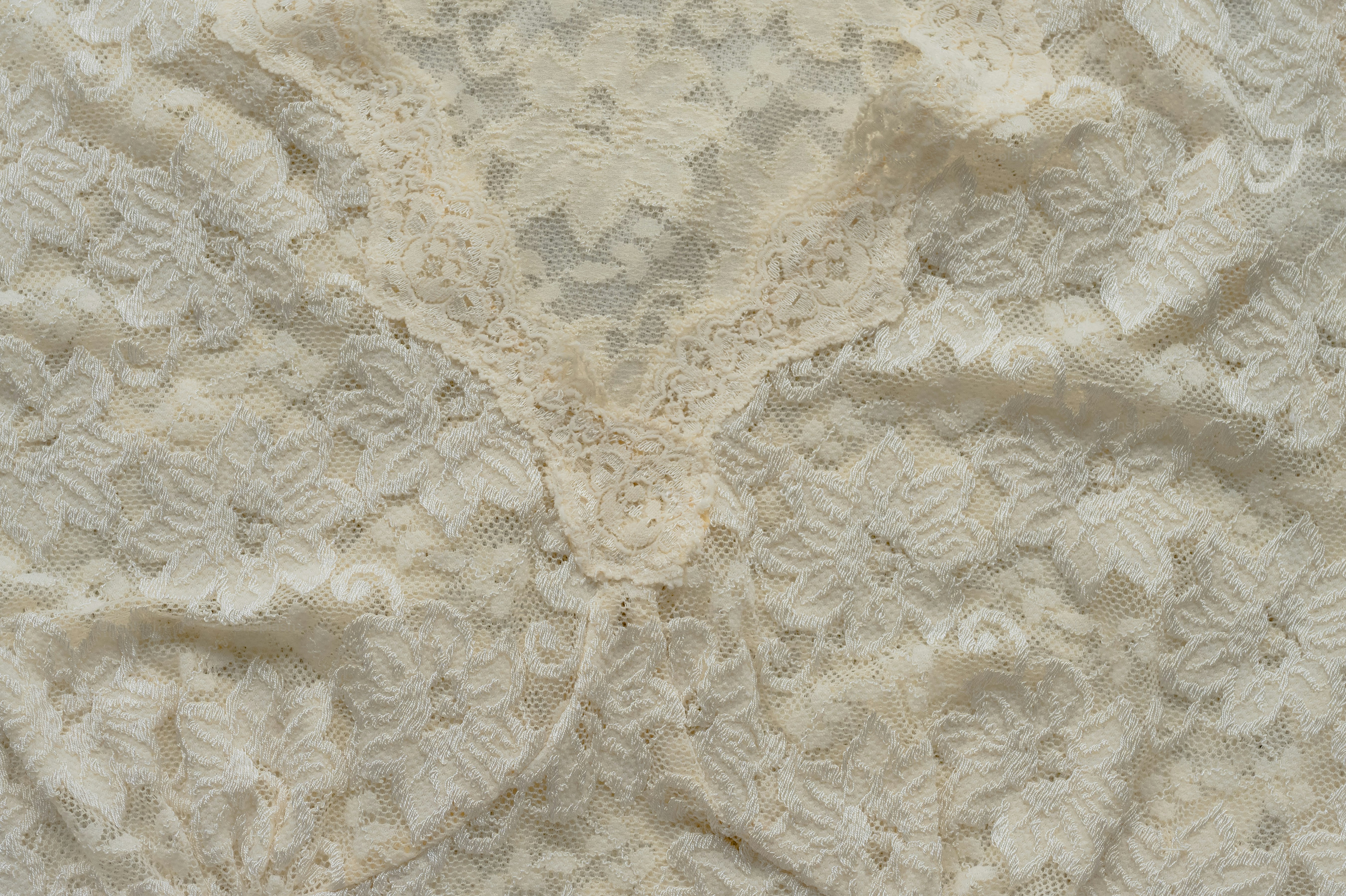 Close-up of delicate cream-colored lace fabric