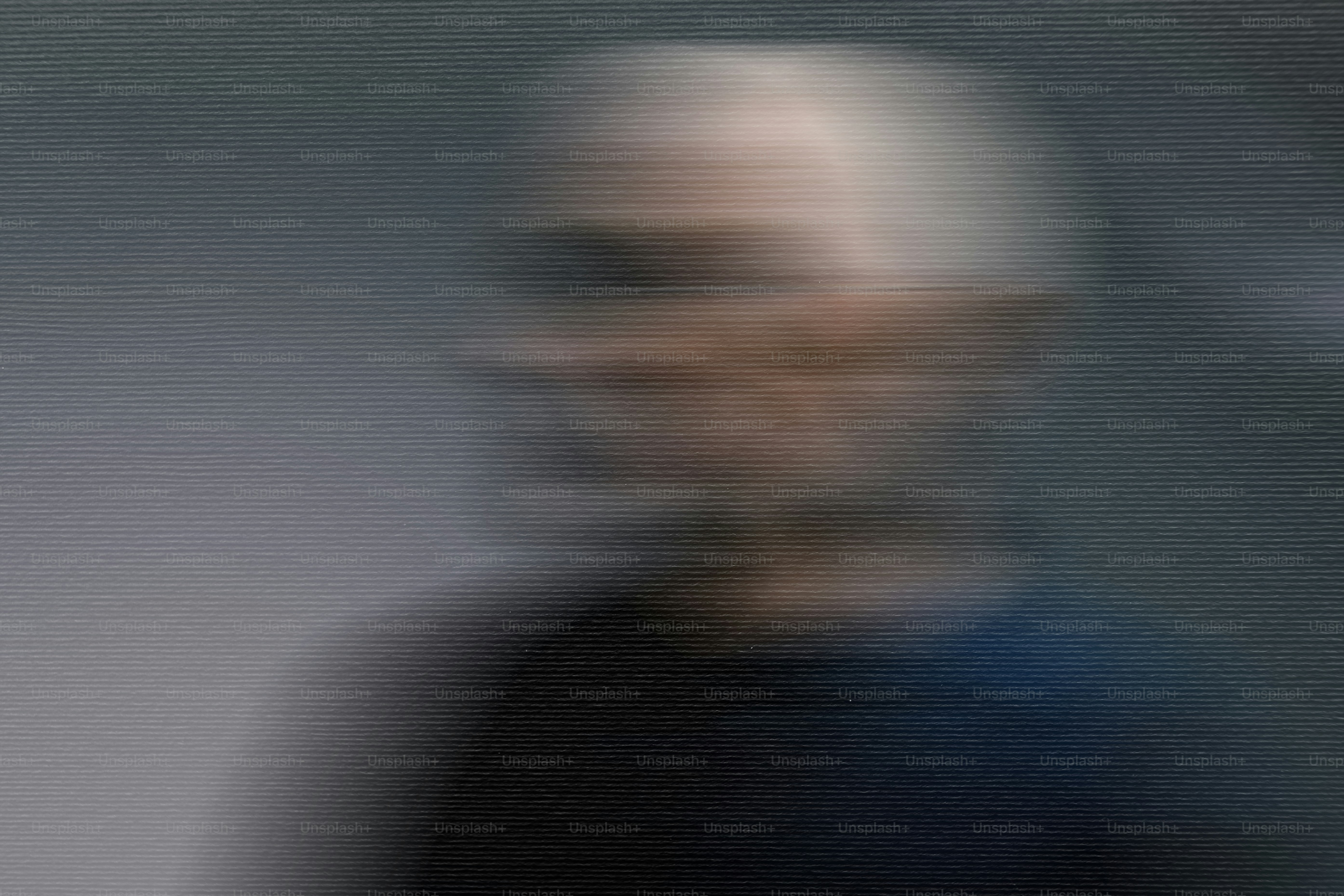 Blurred portrait of an older man with white hair.