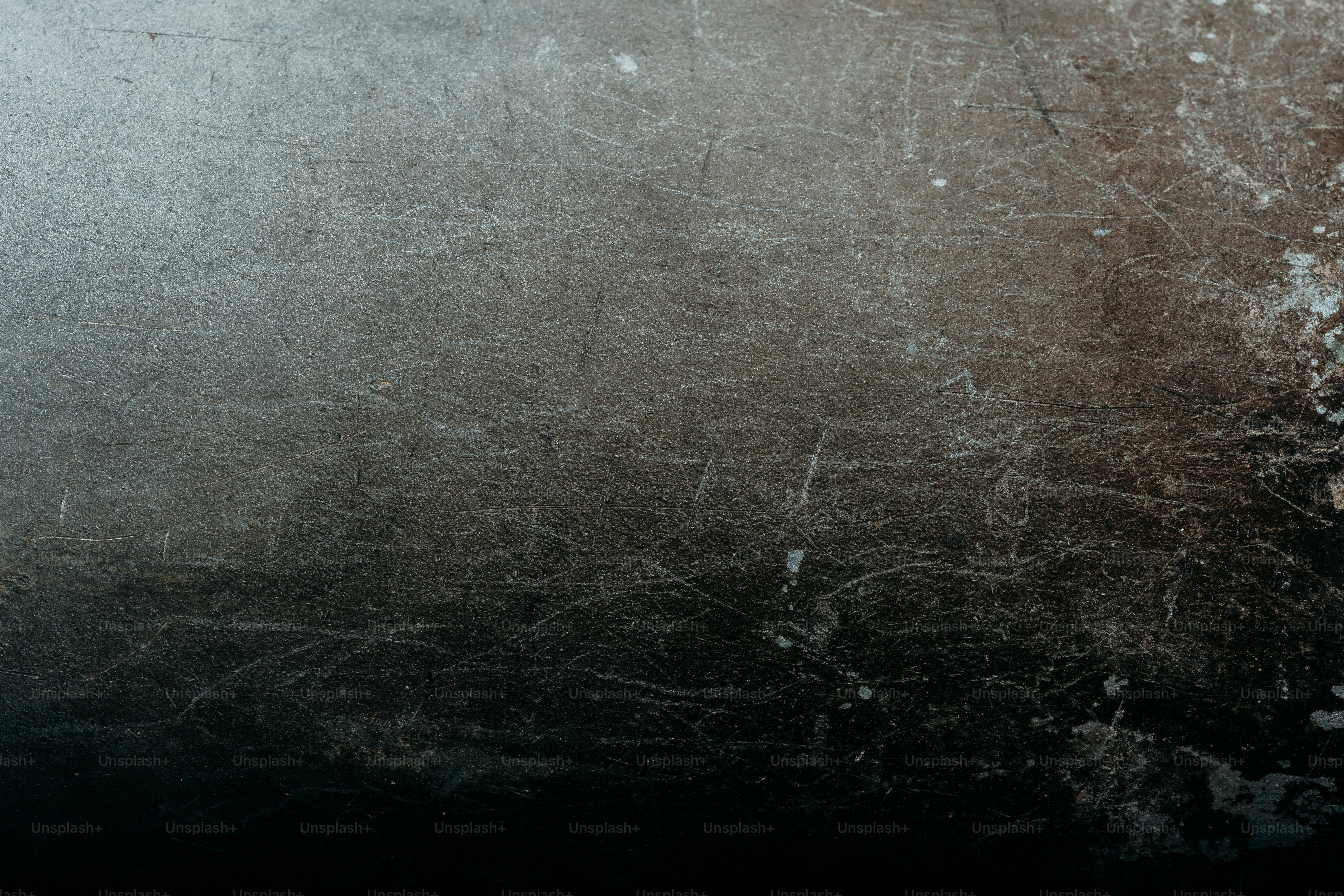 Grungy scratched metal surface with dark gradient