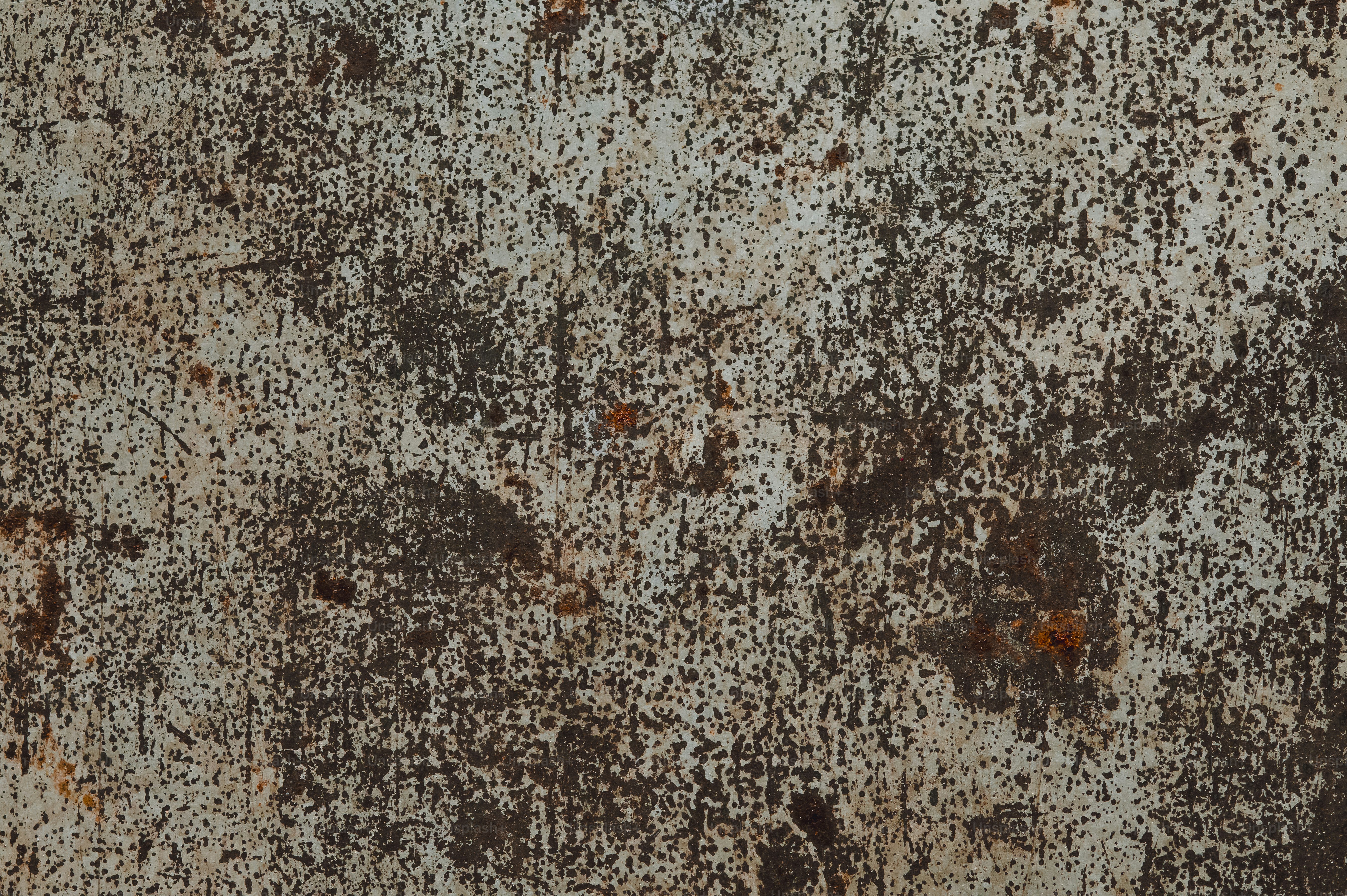 Textured abstract background with rust and white paint.