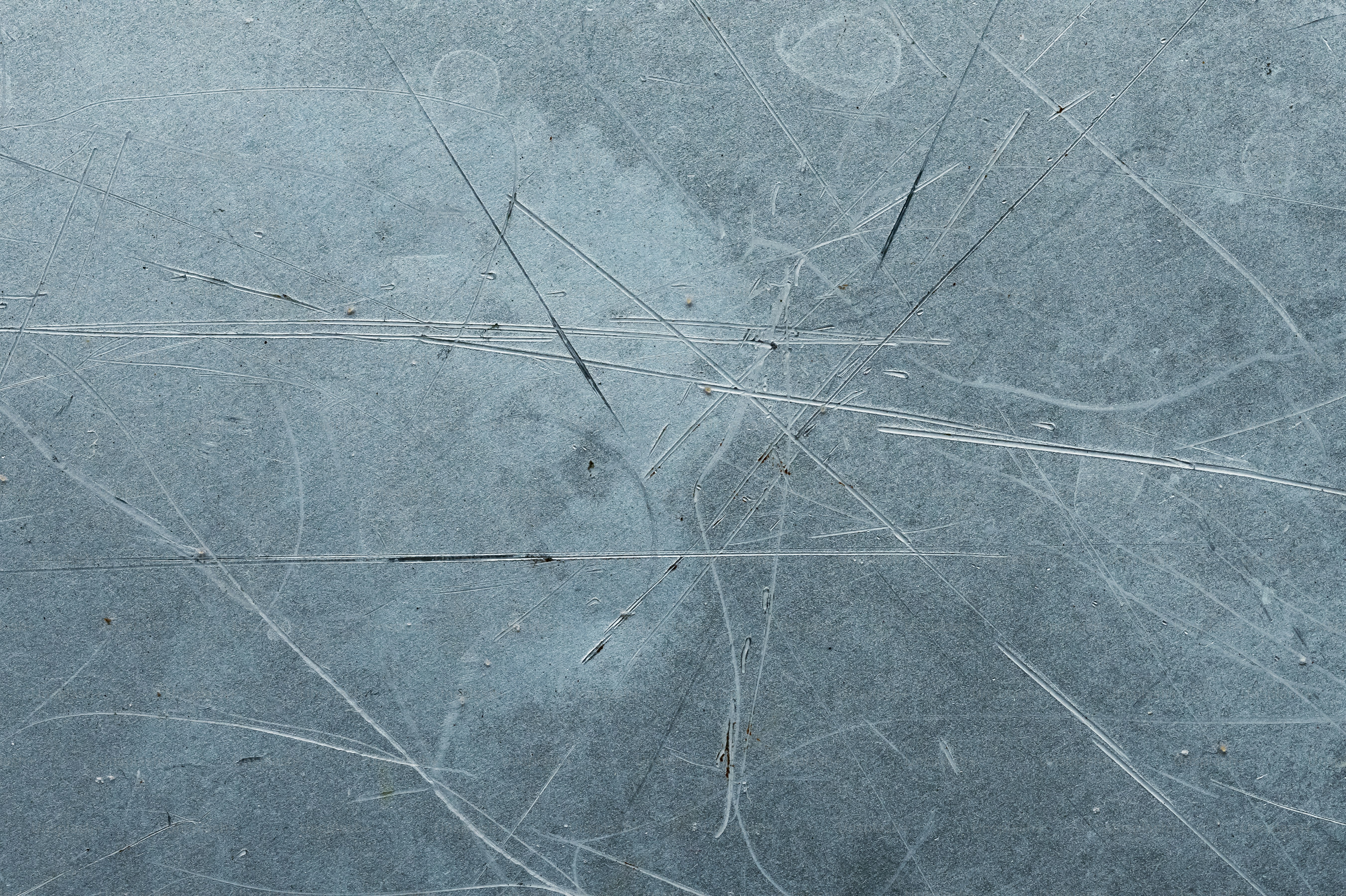 Close-up of scratched ice surface with skate marks