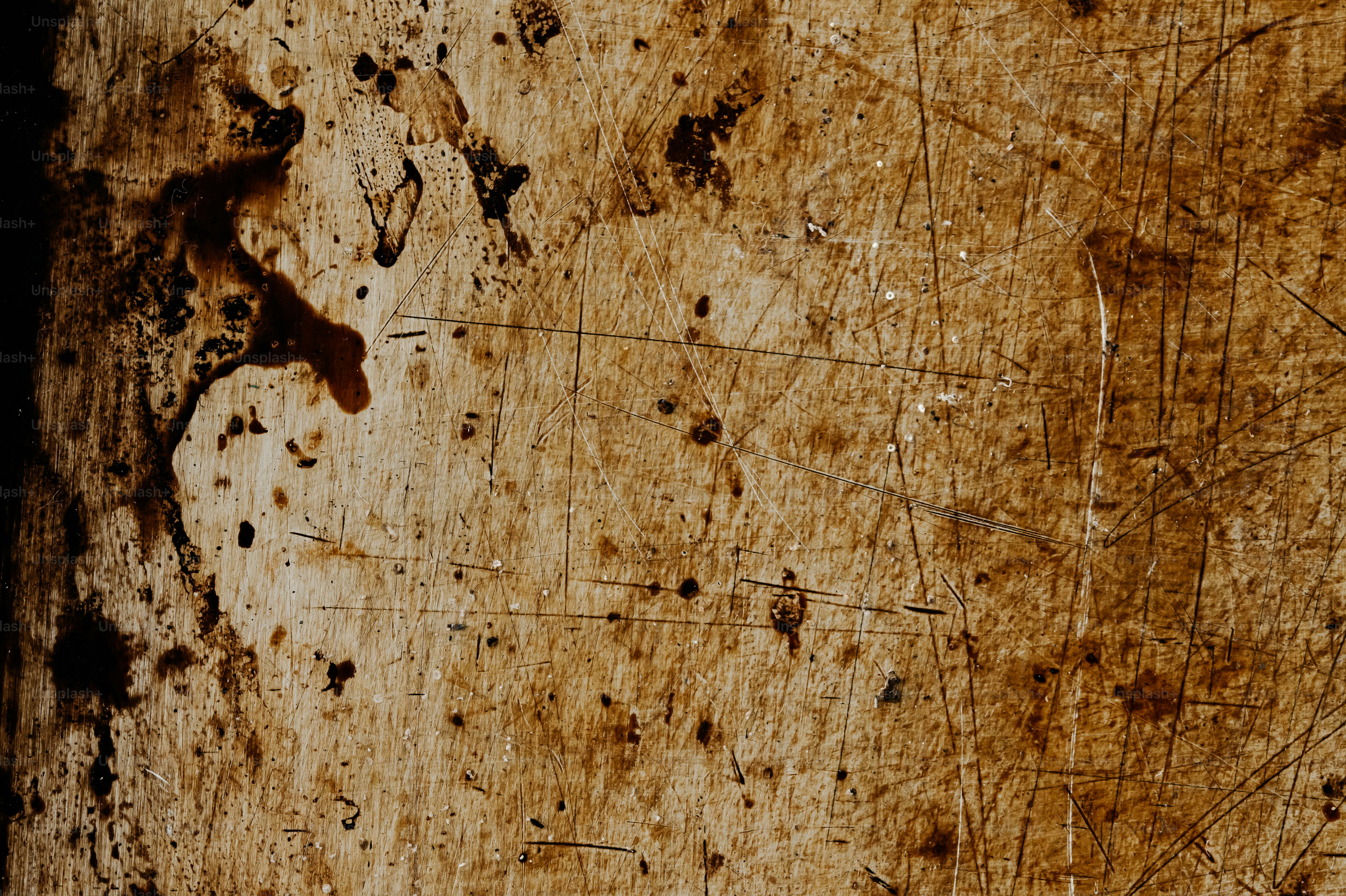 Close-up of weathered wood with scratches and stains