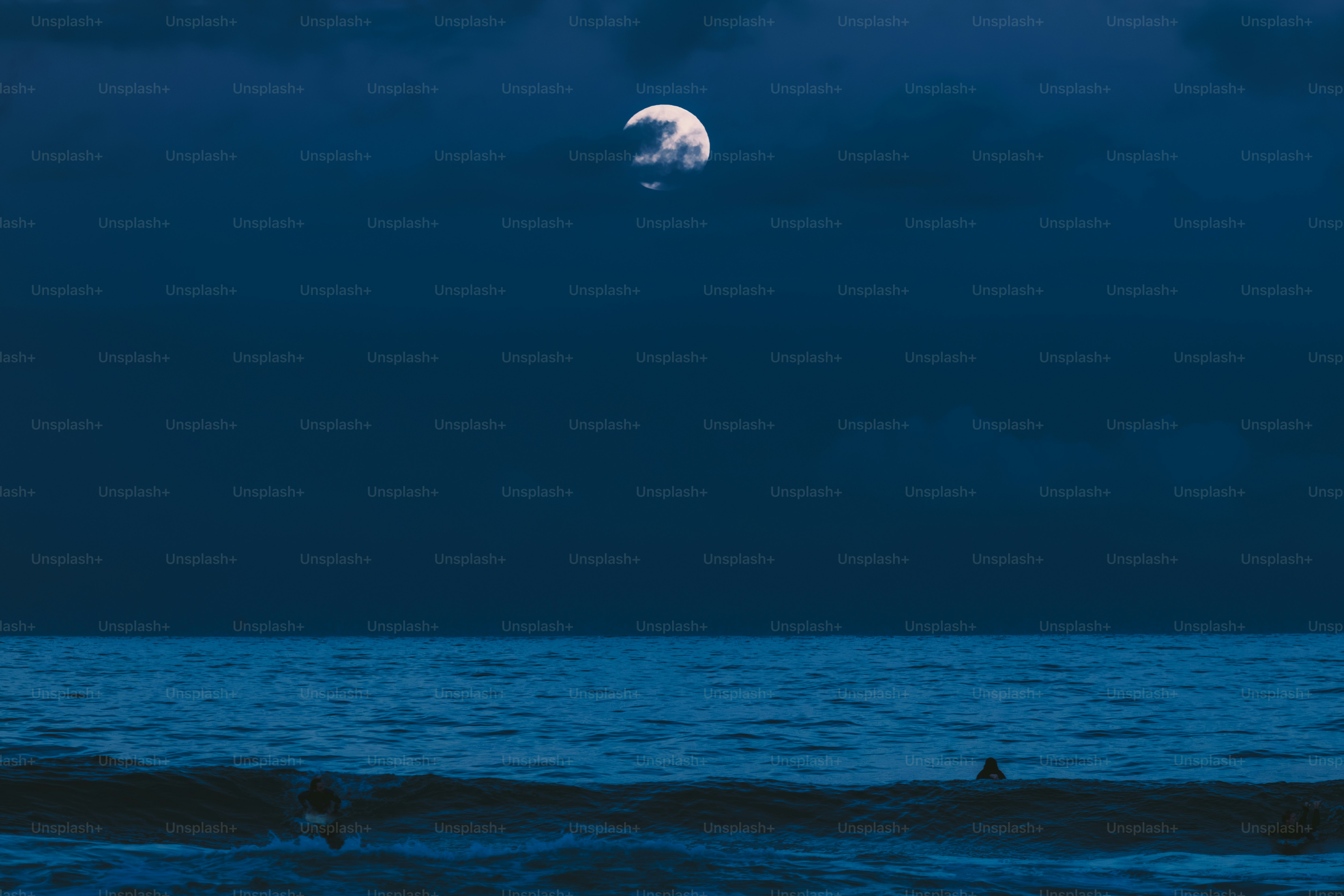 Full moon over the ocean at night