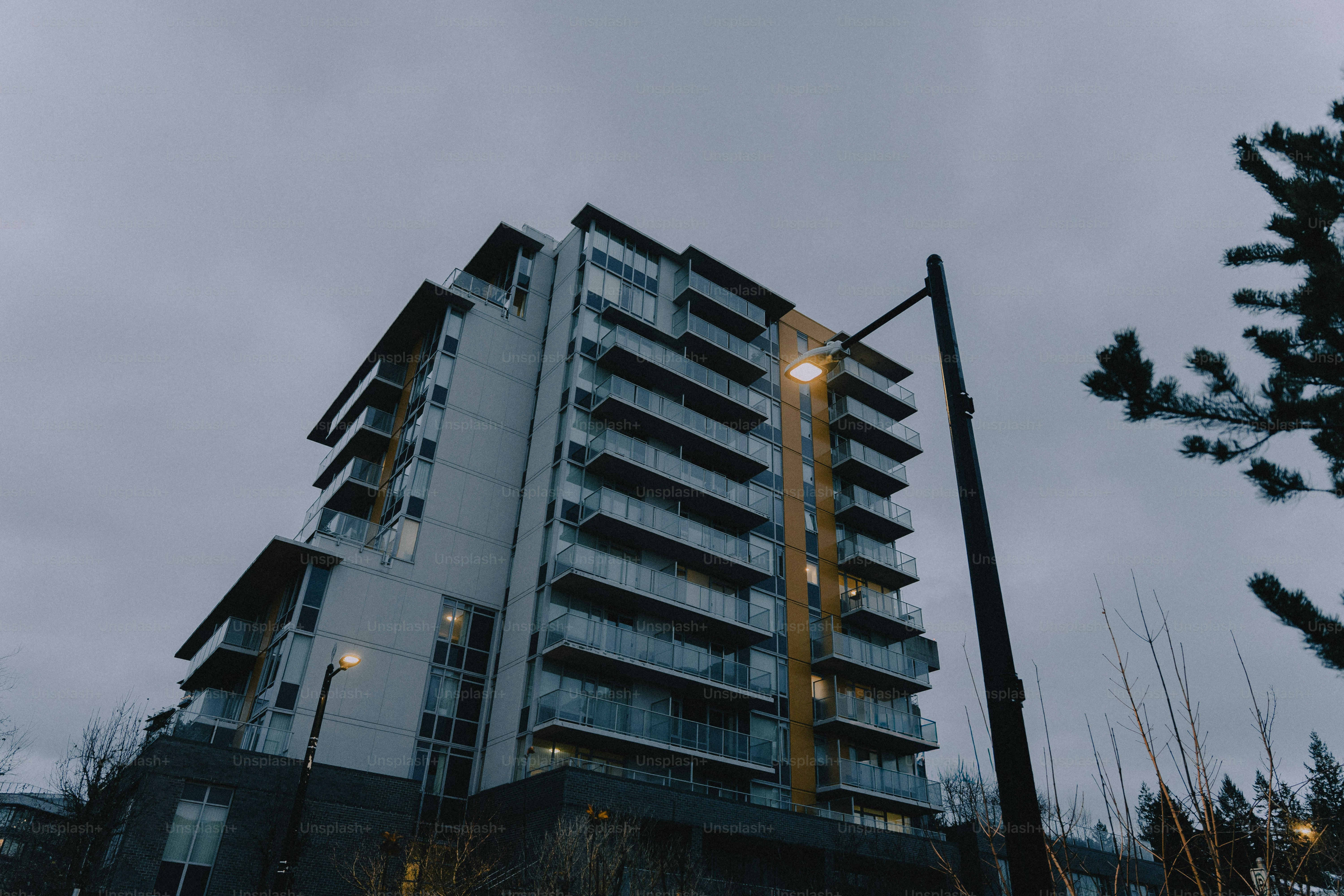 Modern apartment building with balconies under cloudy sky