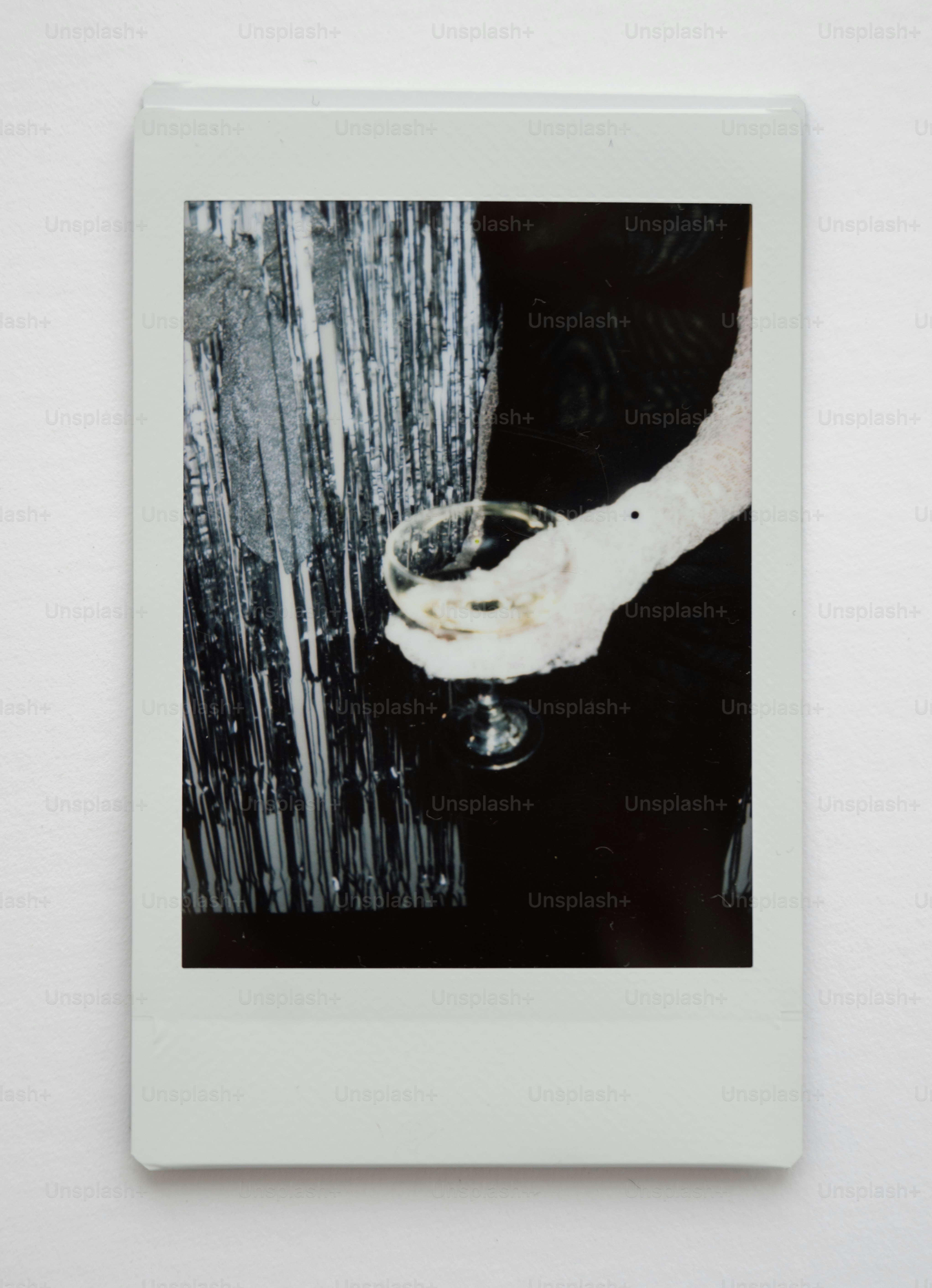 Hand holding champagne glass with festive background
