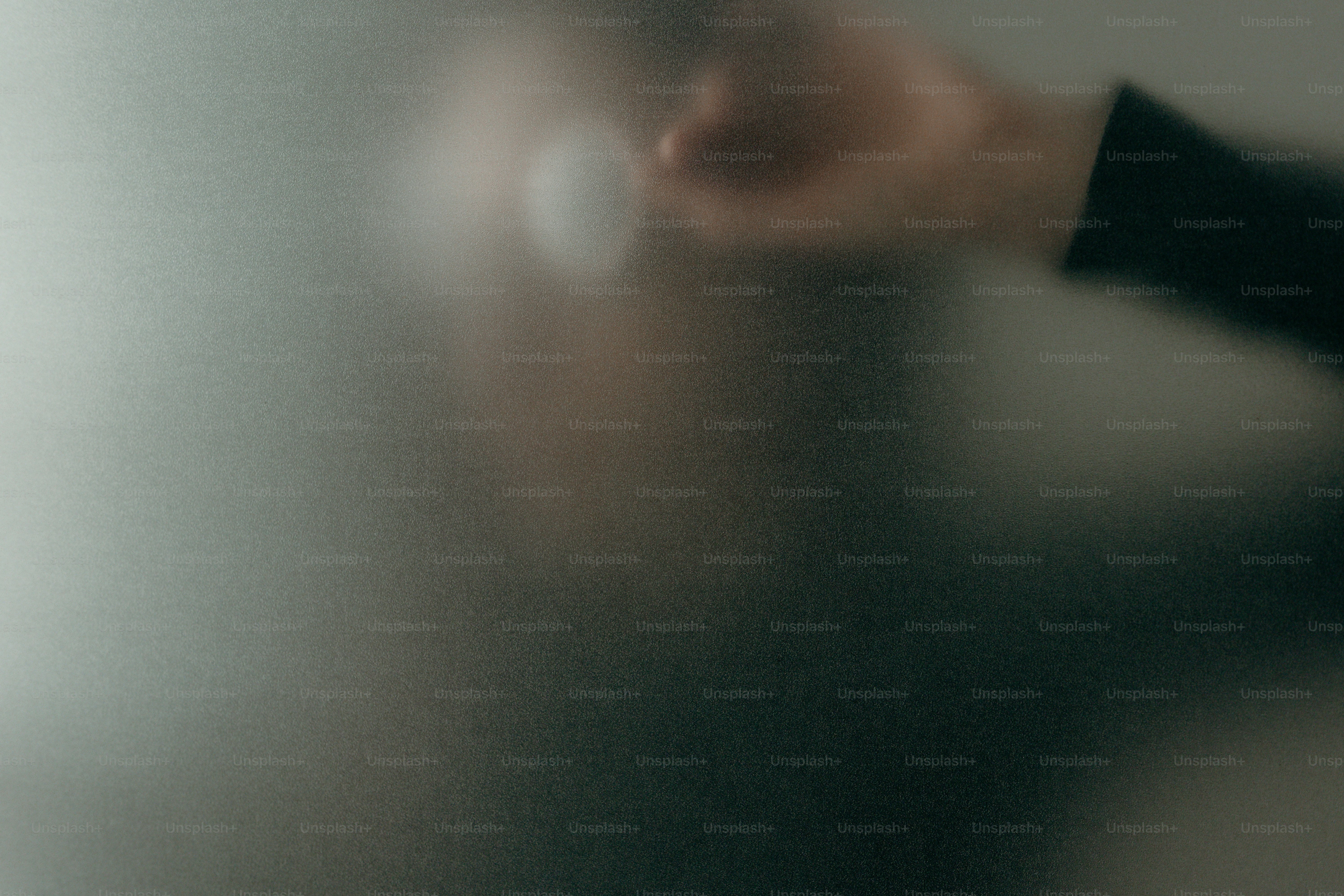 Blurred silhouette of a person reaching out