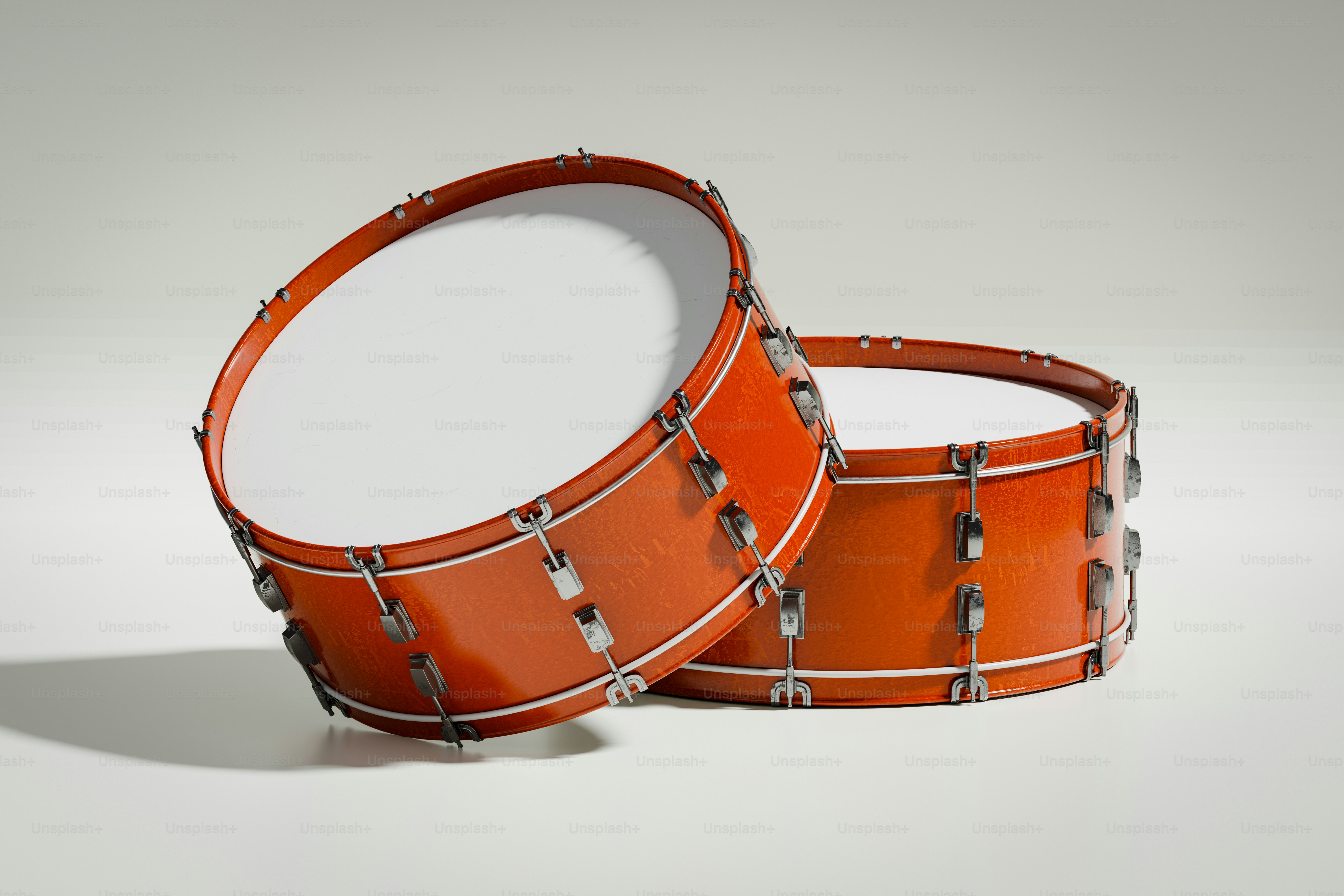 Two orange drums on a white background