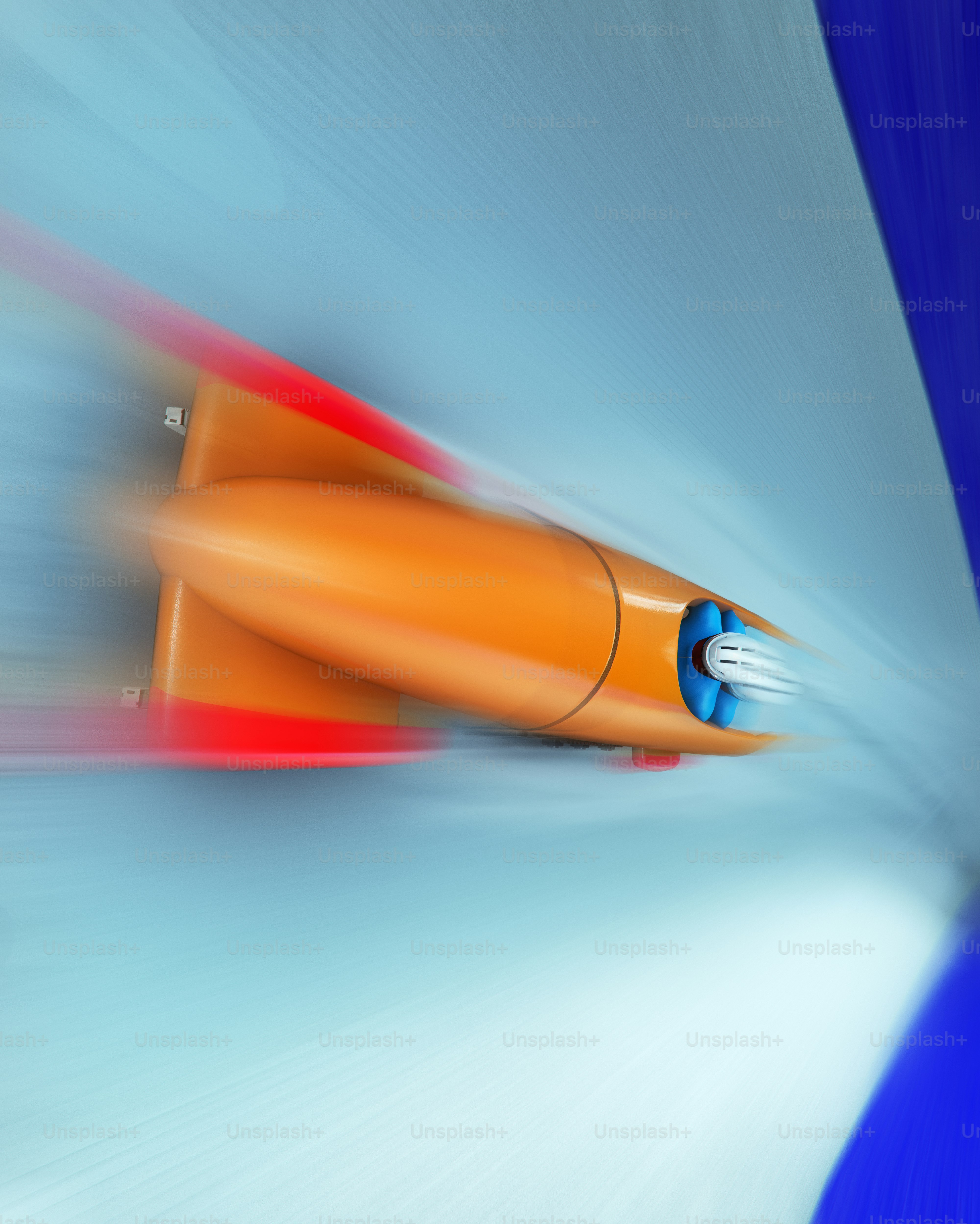 Orange bobsled speeding down a blue track