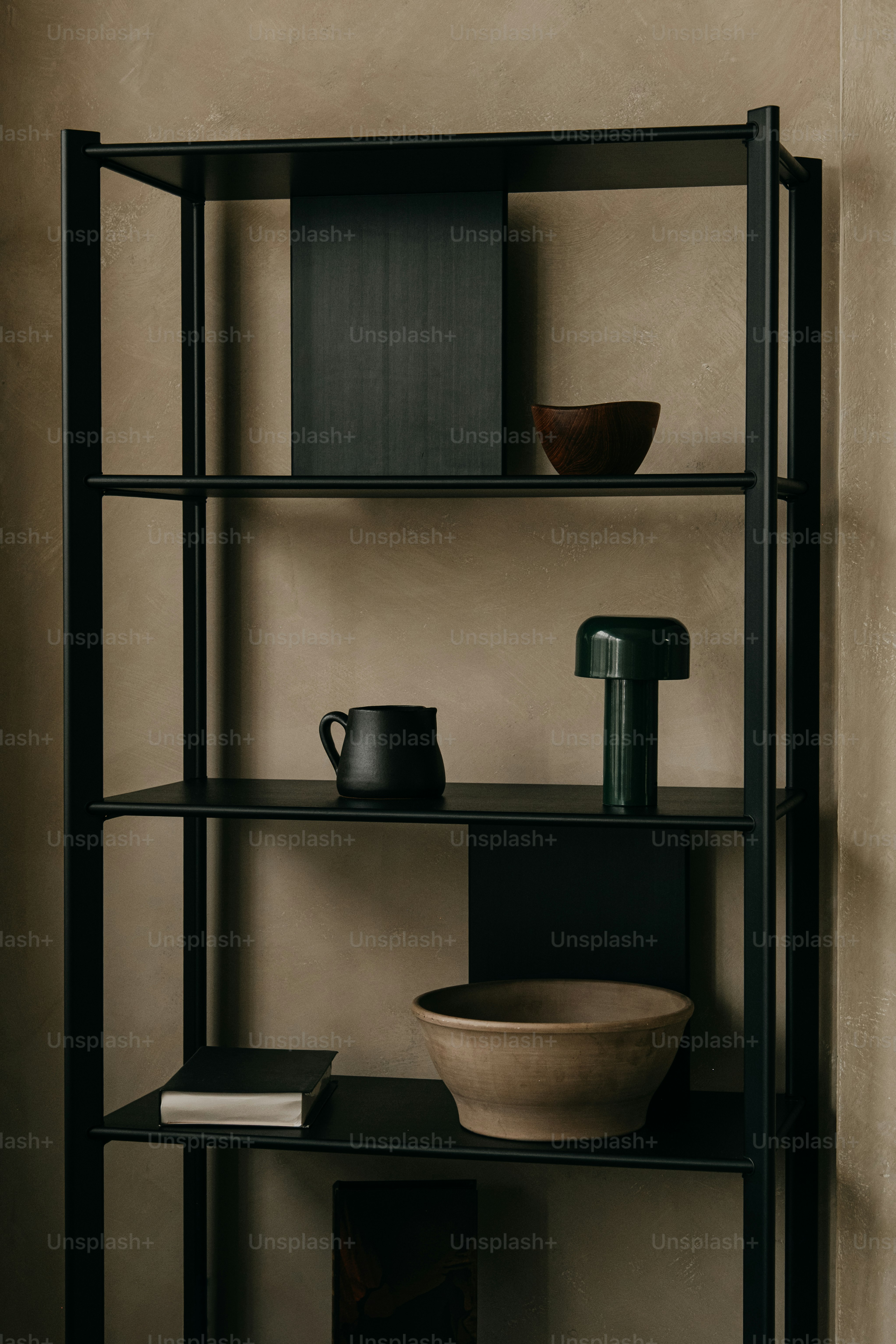 Black metal shelving unit with decorative objects.