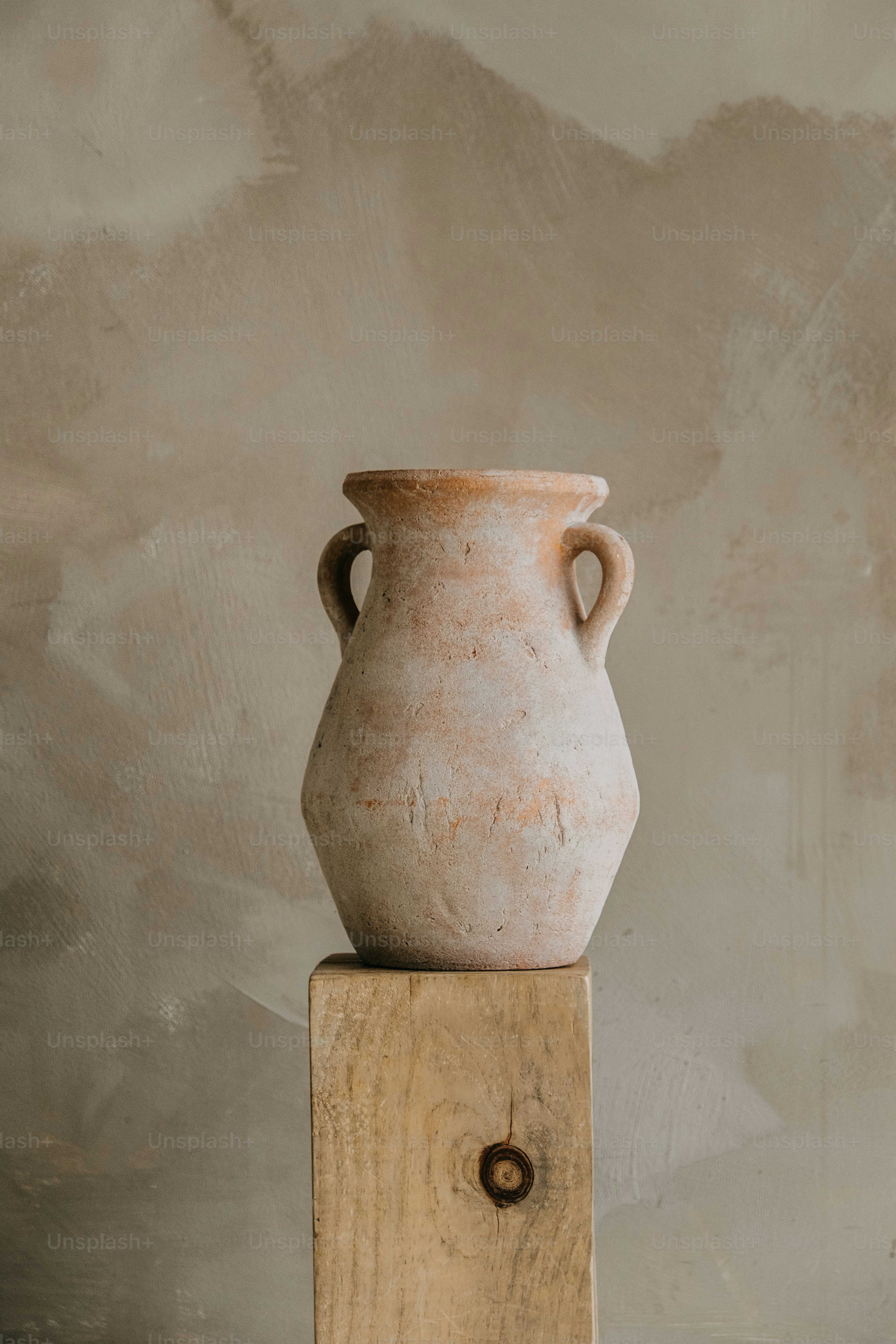 Terracotta amphora on a wooden block
