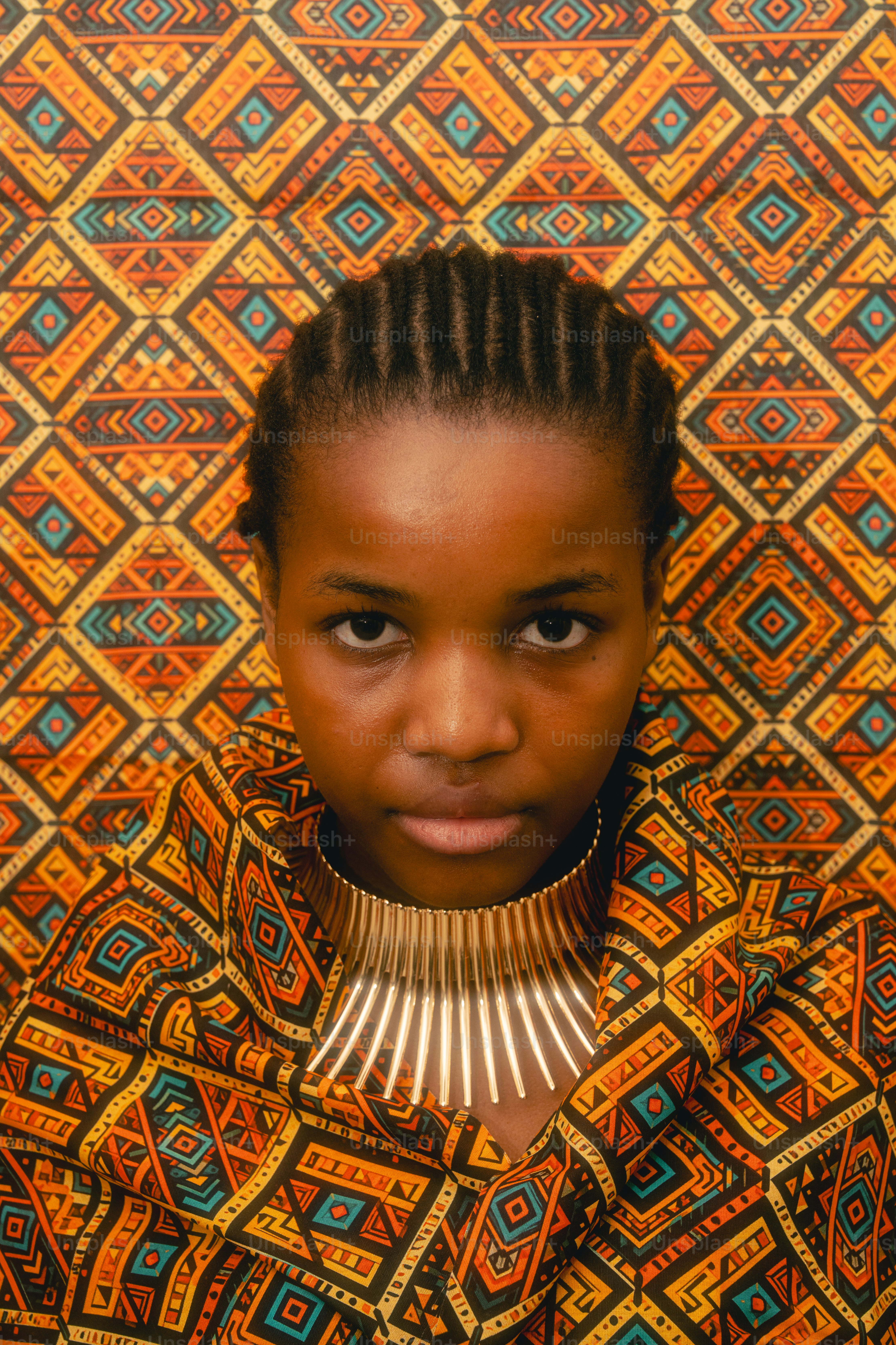 Young woman with braided hair and bold necklace