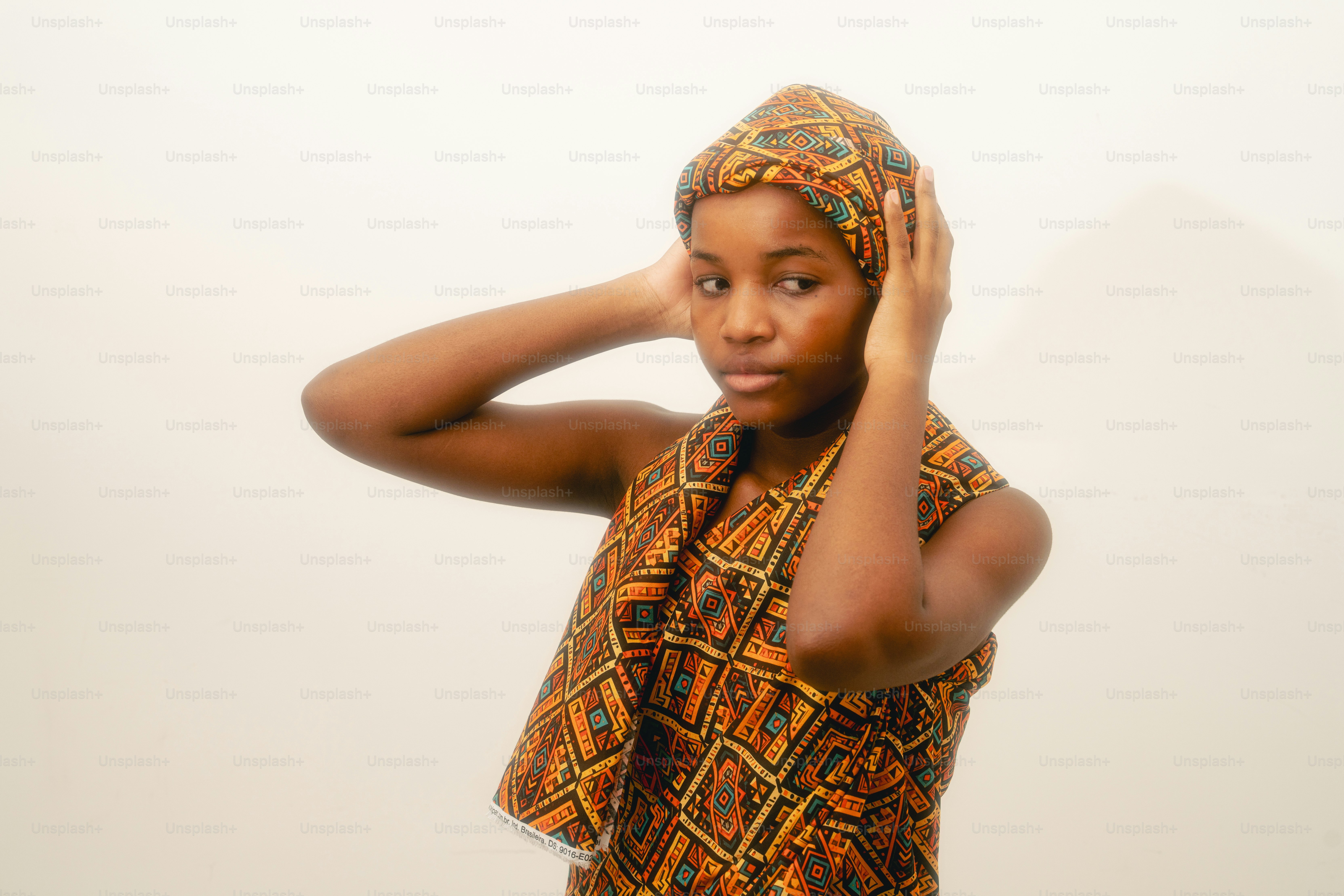 Young woman wearing a patterned headwrap and scarf