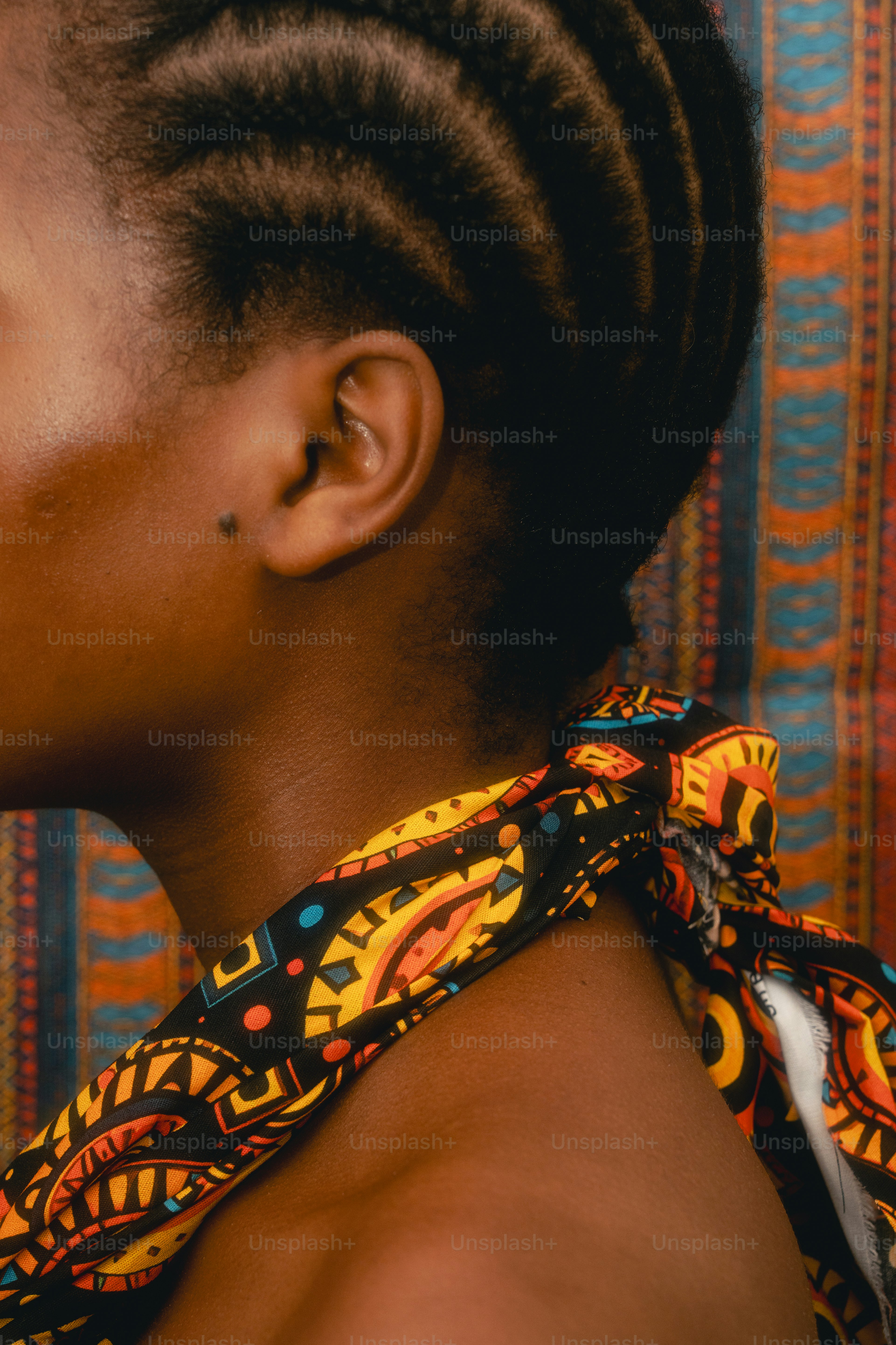 Woman with braided hair and colorful scarf