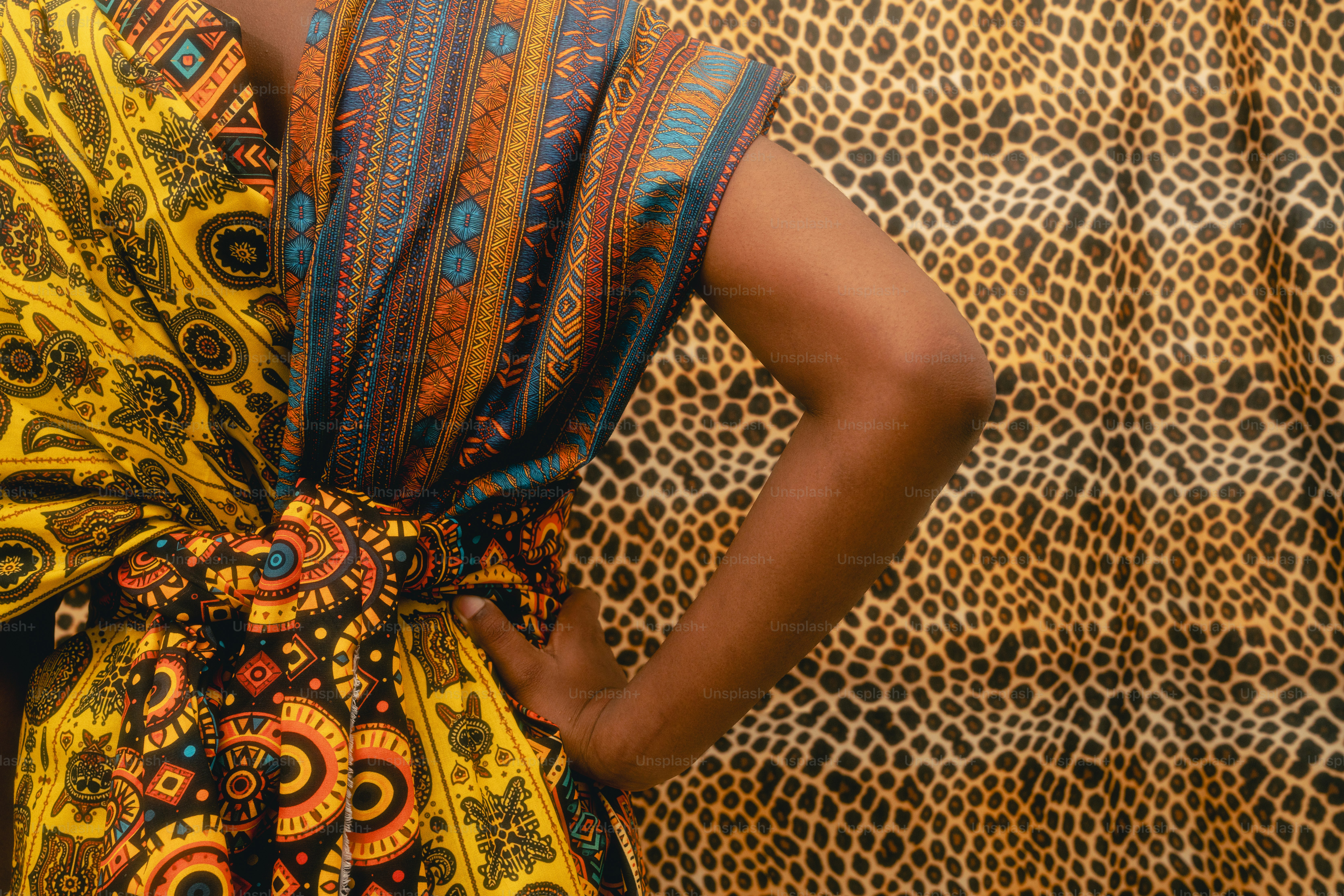 Woman in colorful patterned clothing with leopard print background