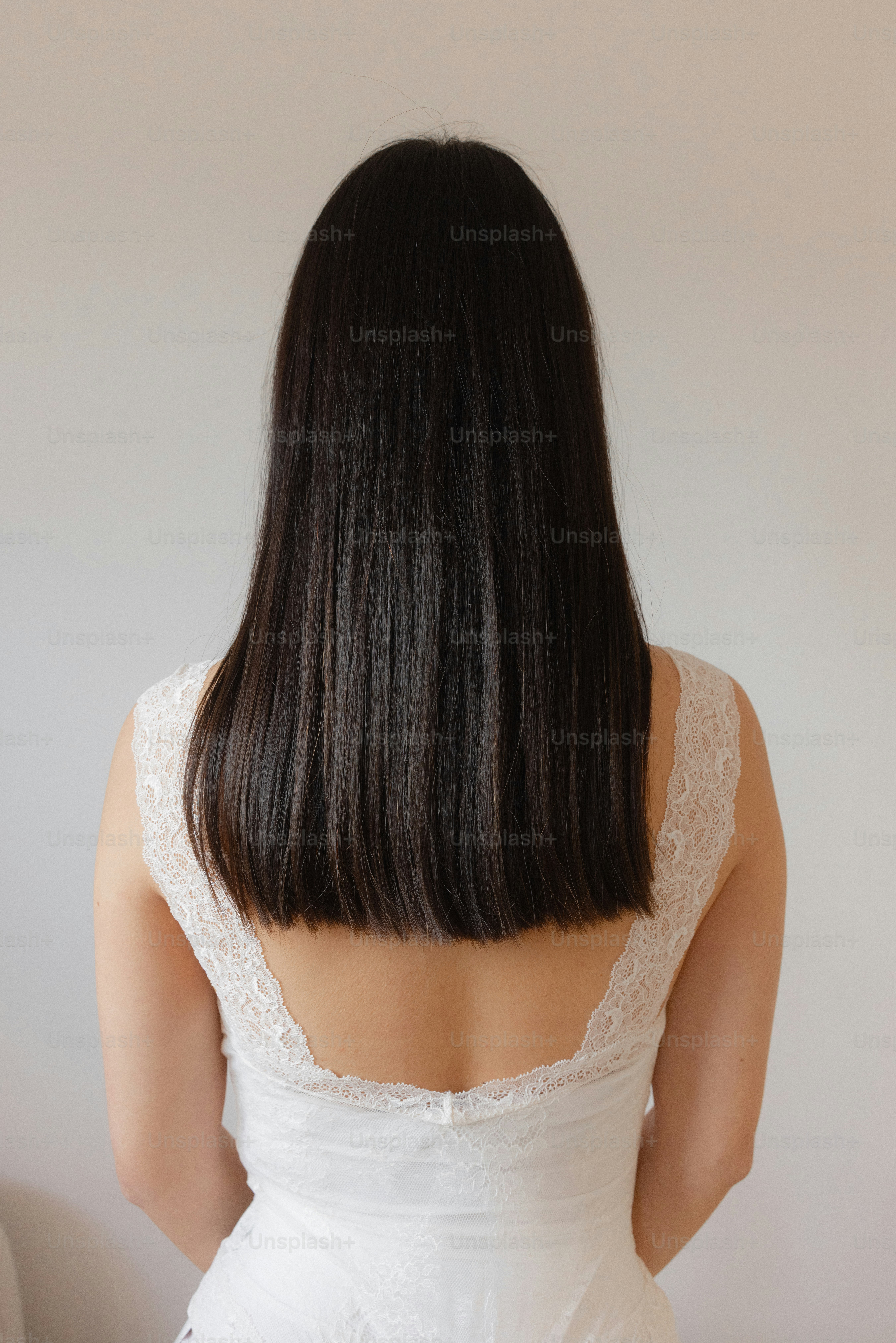 Back view of a woman with long, dark hair.