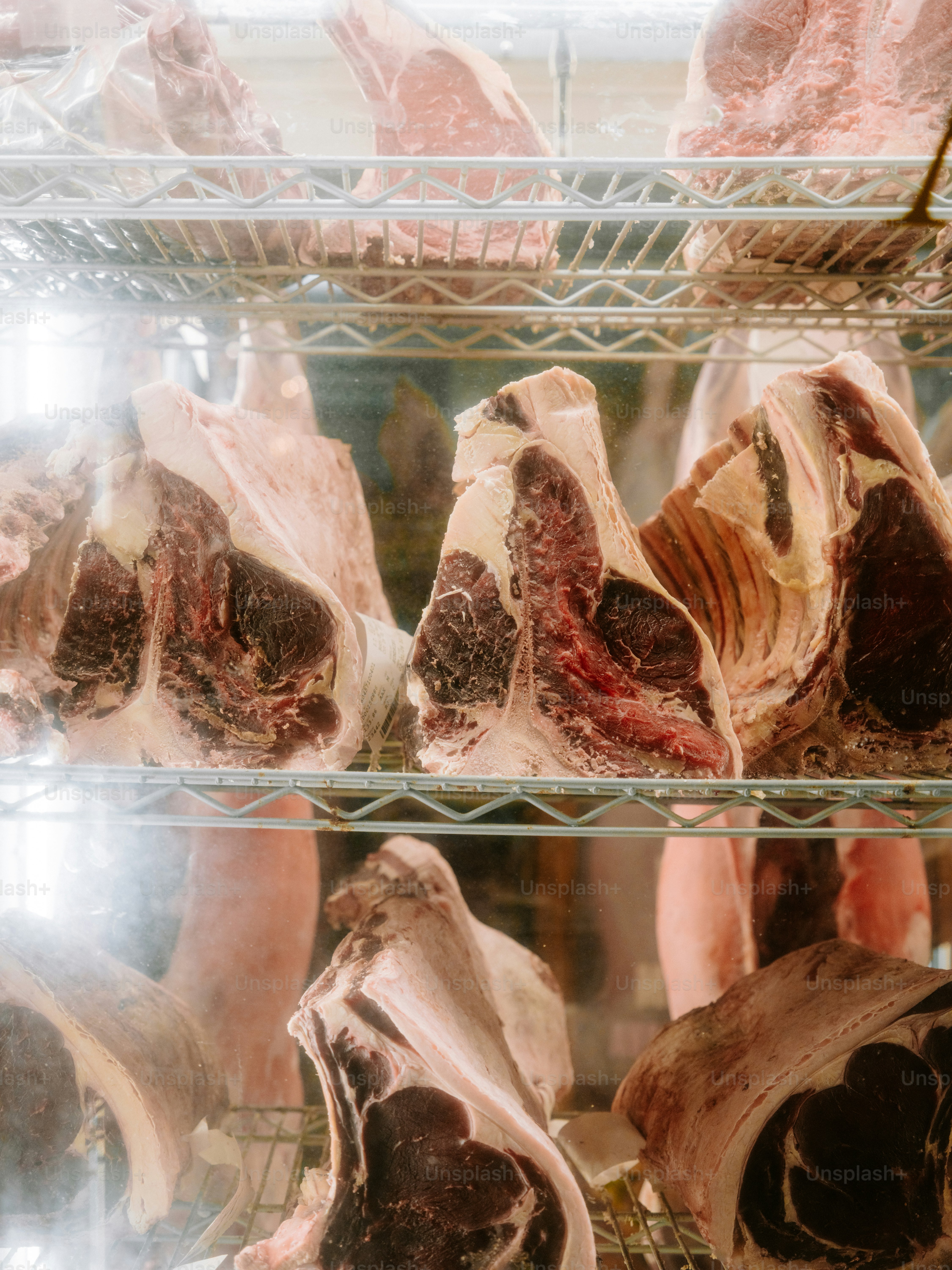 Aged beef cuts displayed on refrigerator shelves