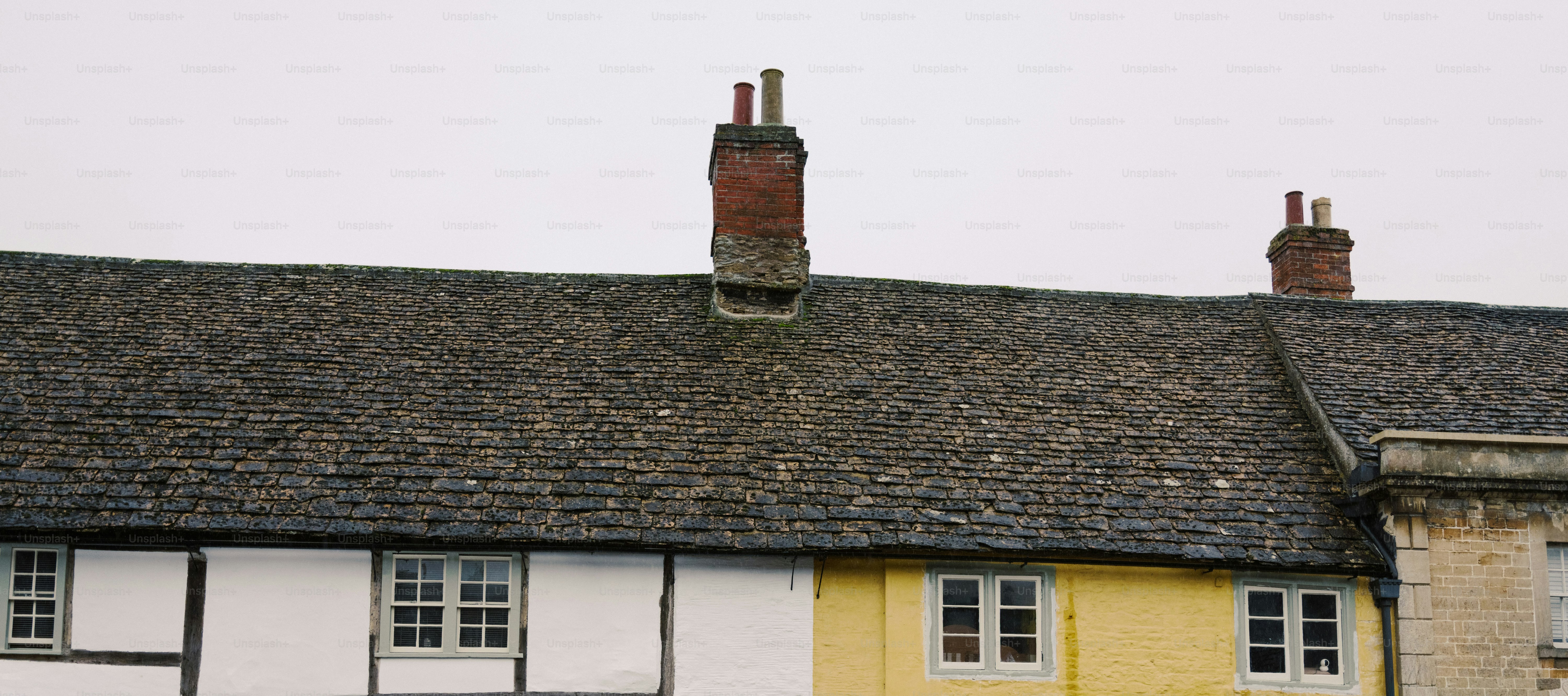 Row of traditional english cottages with stone roofs.