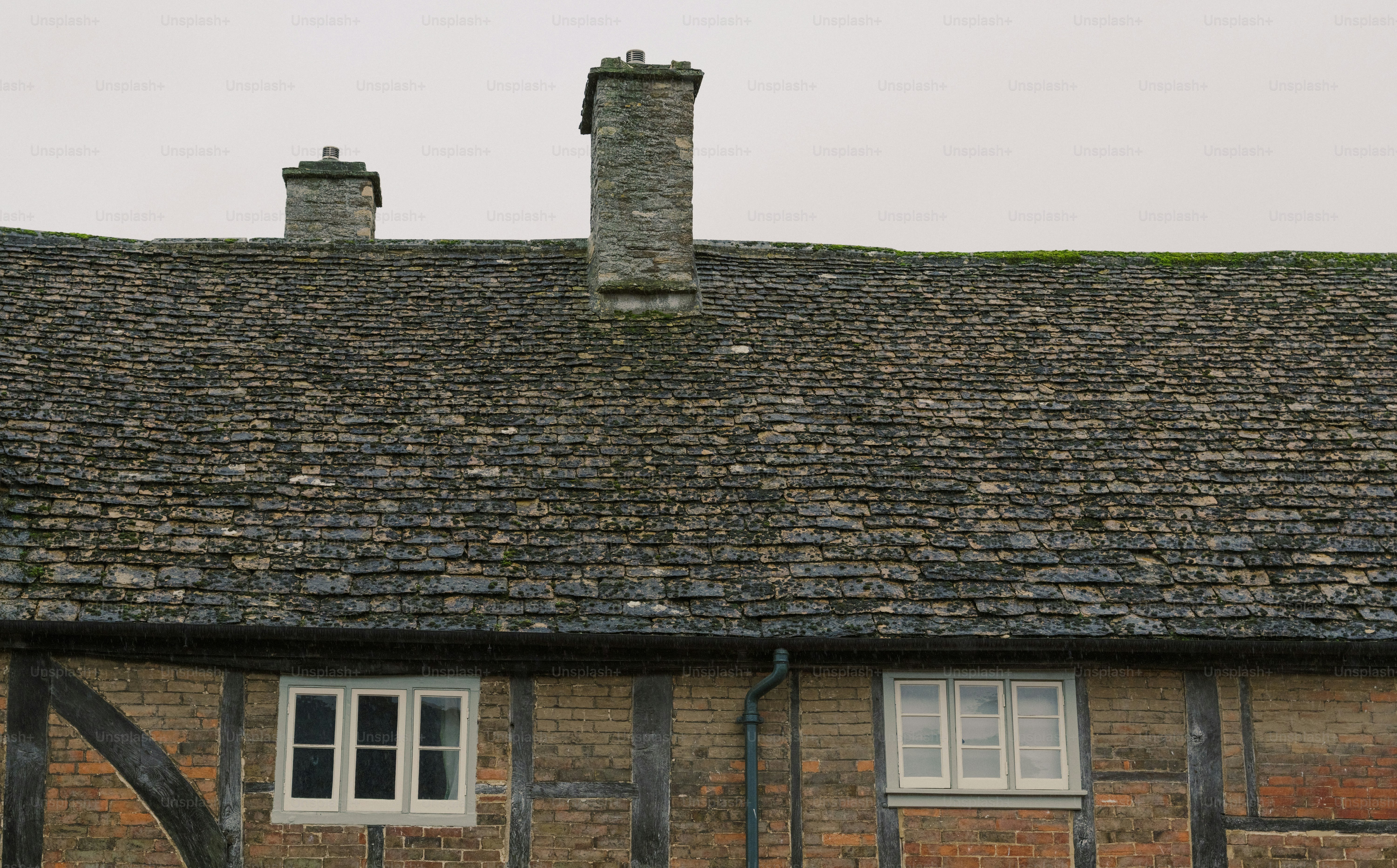 Old stone chimneys on a thatched roof