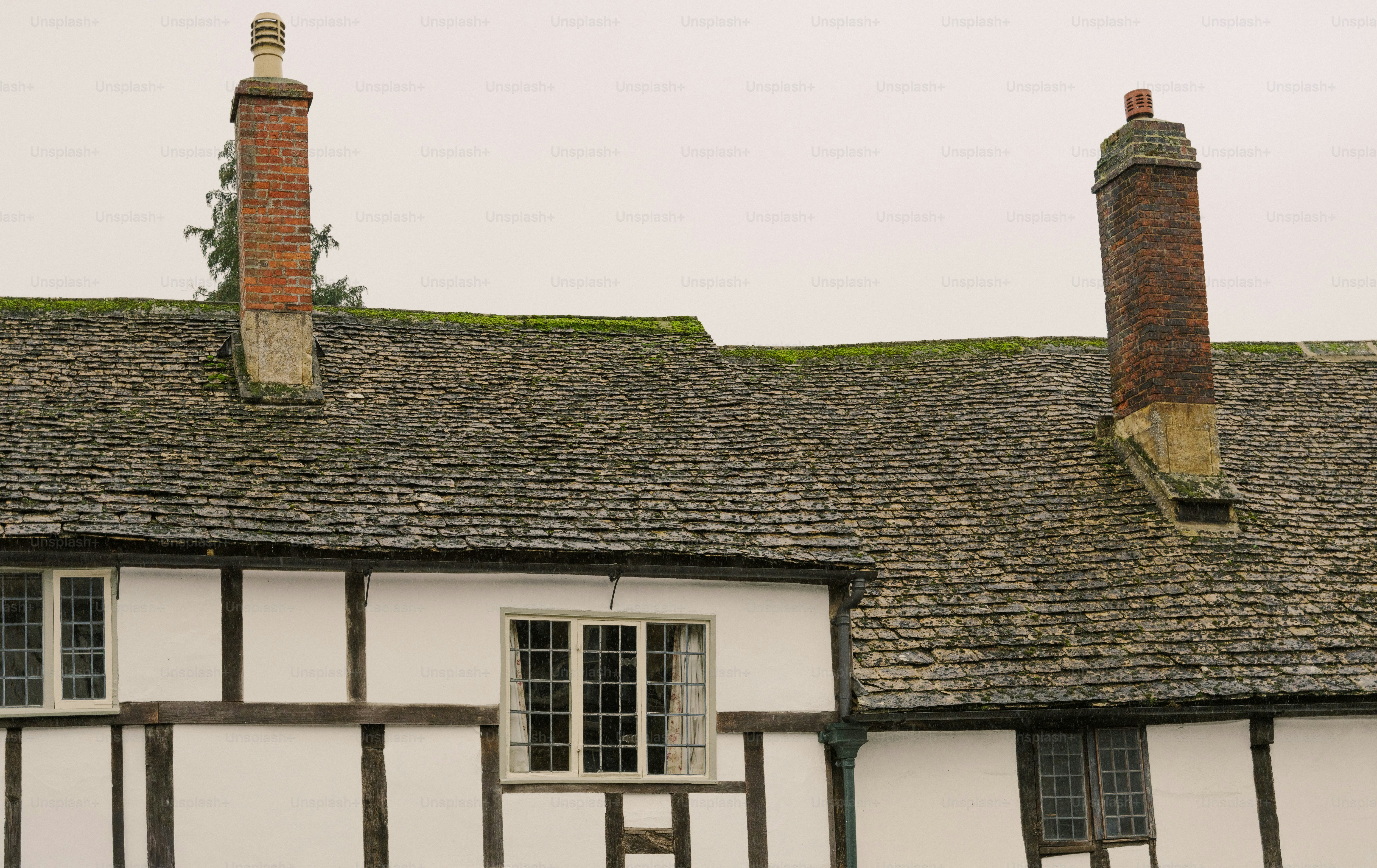 Historic timber-framed building with stone roof