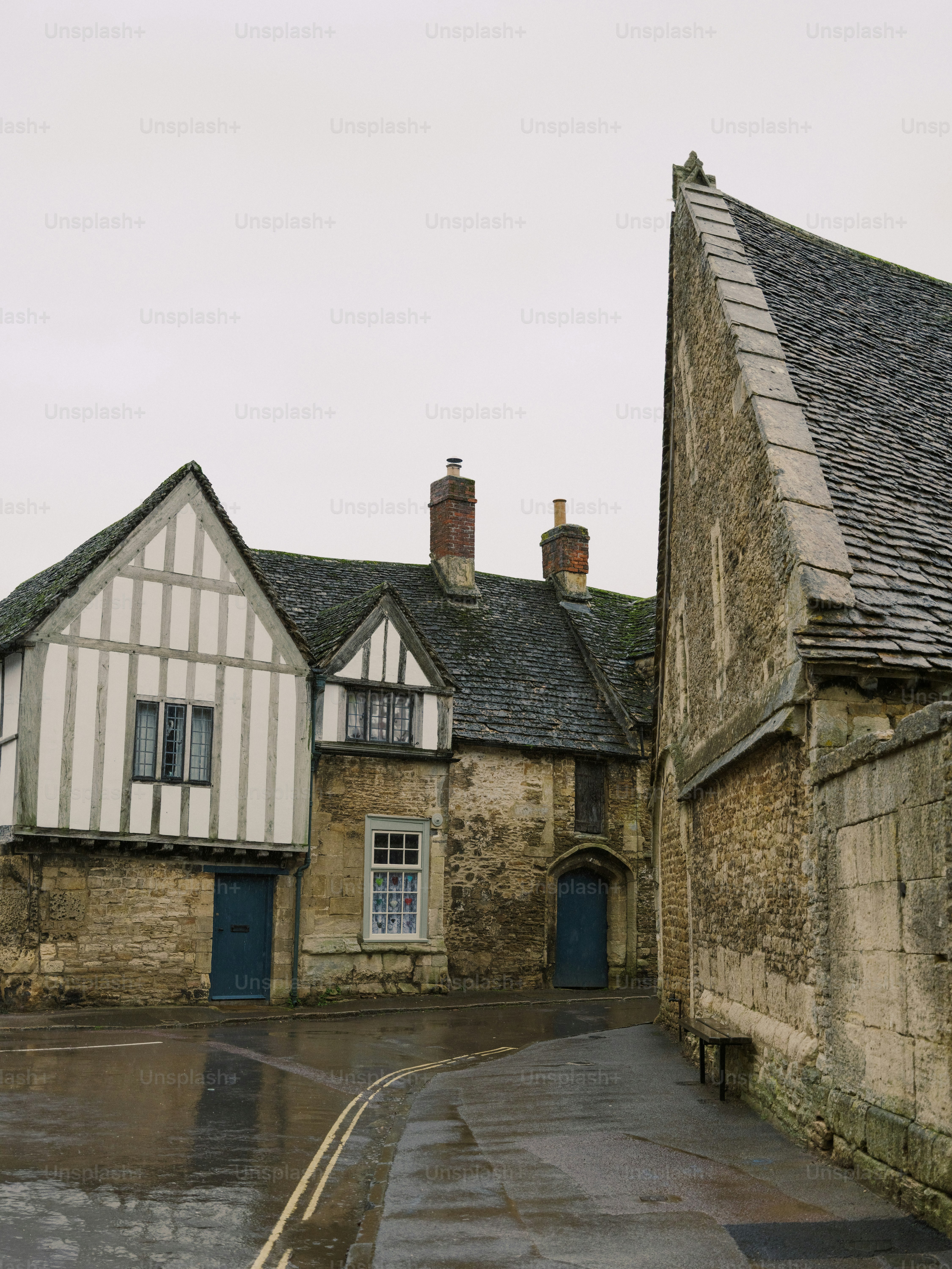 Historic stone buildings with timber framing on a wet street