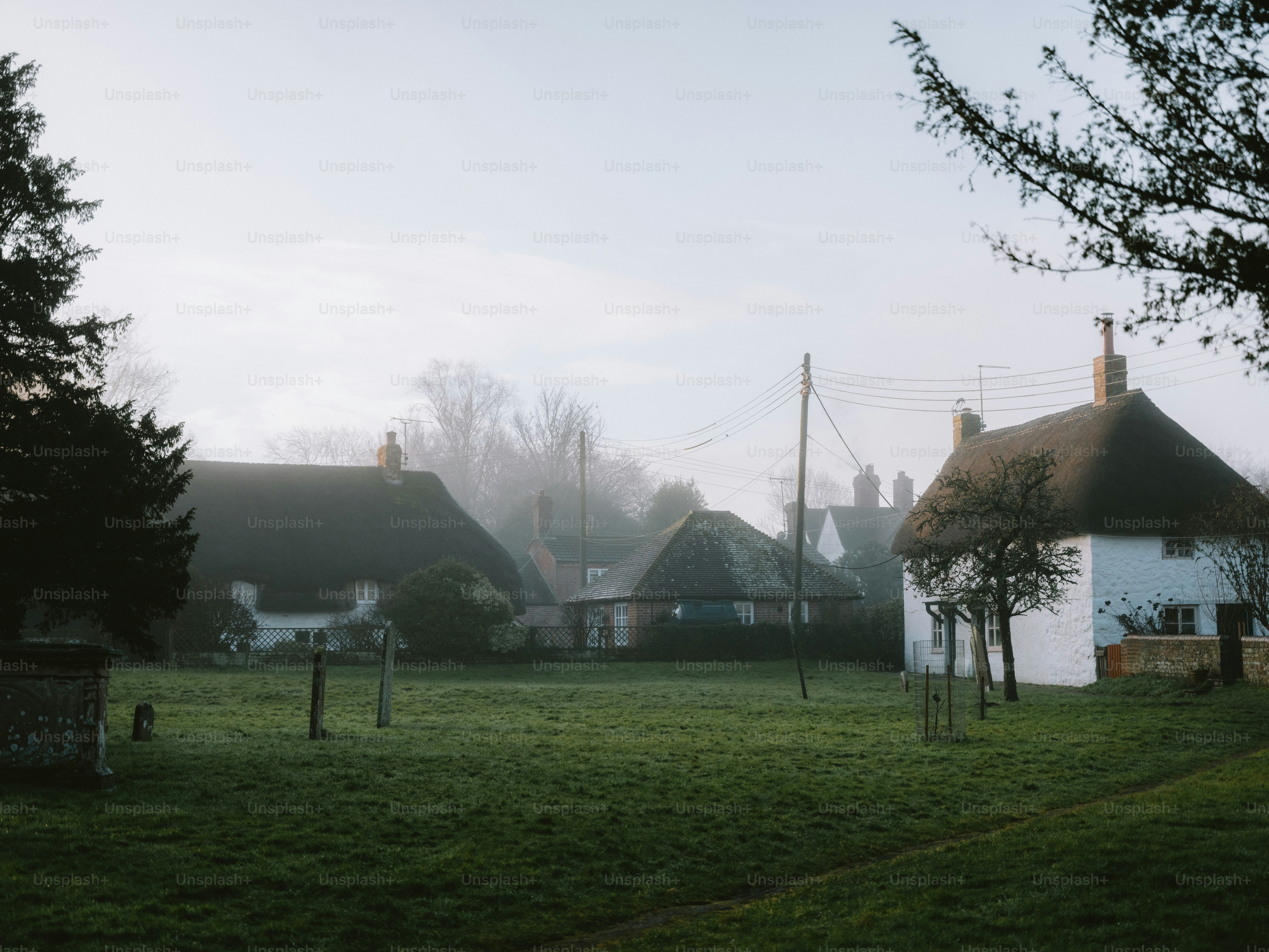 Misty morning over a quaint english village green