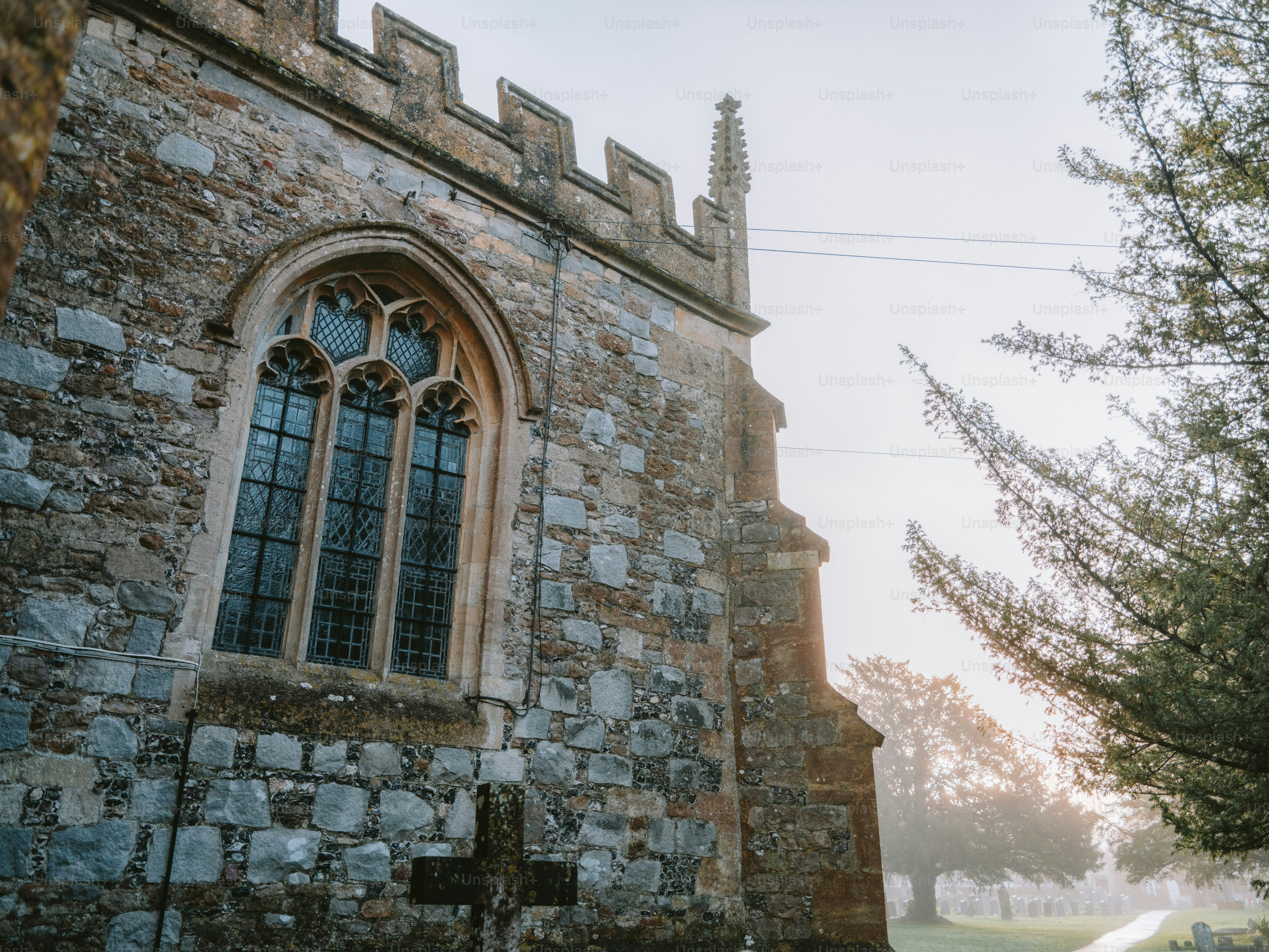 Stone church with gothic window at sunrise