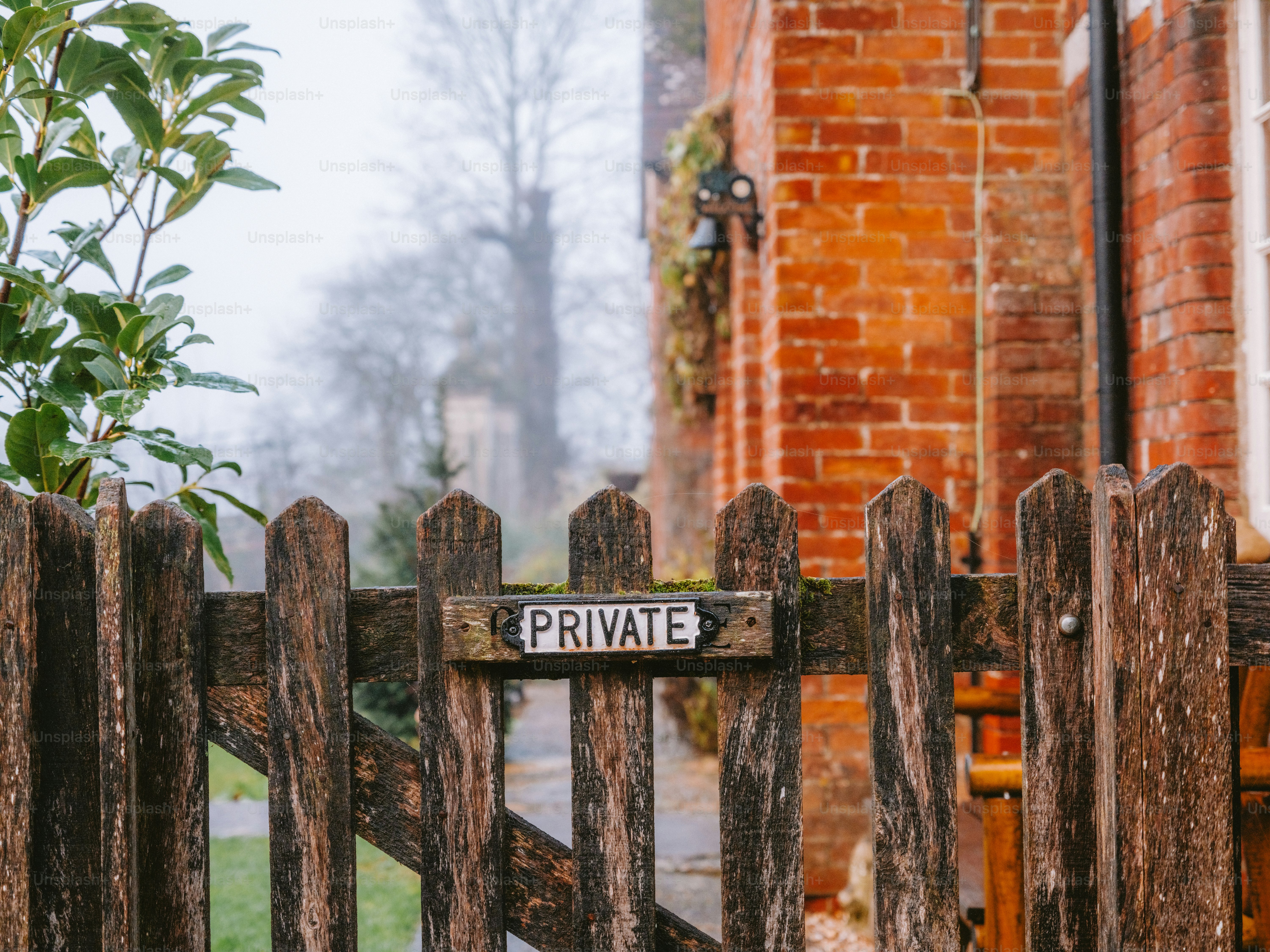 Wooden gate with a sign that says private.