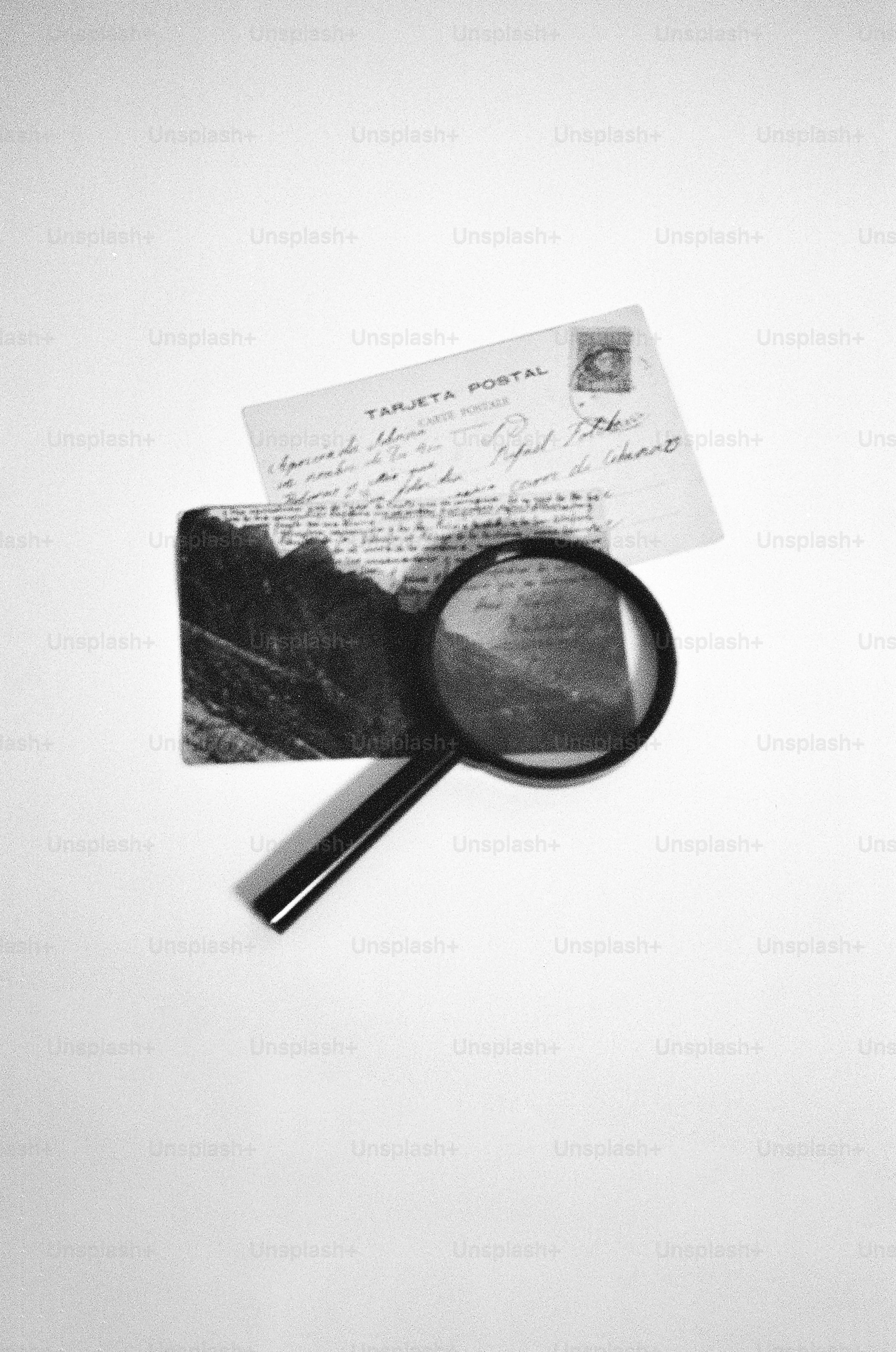 Magnifying glass over old postcard and photograph
