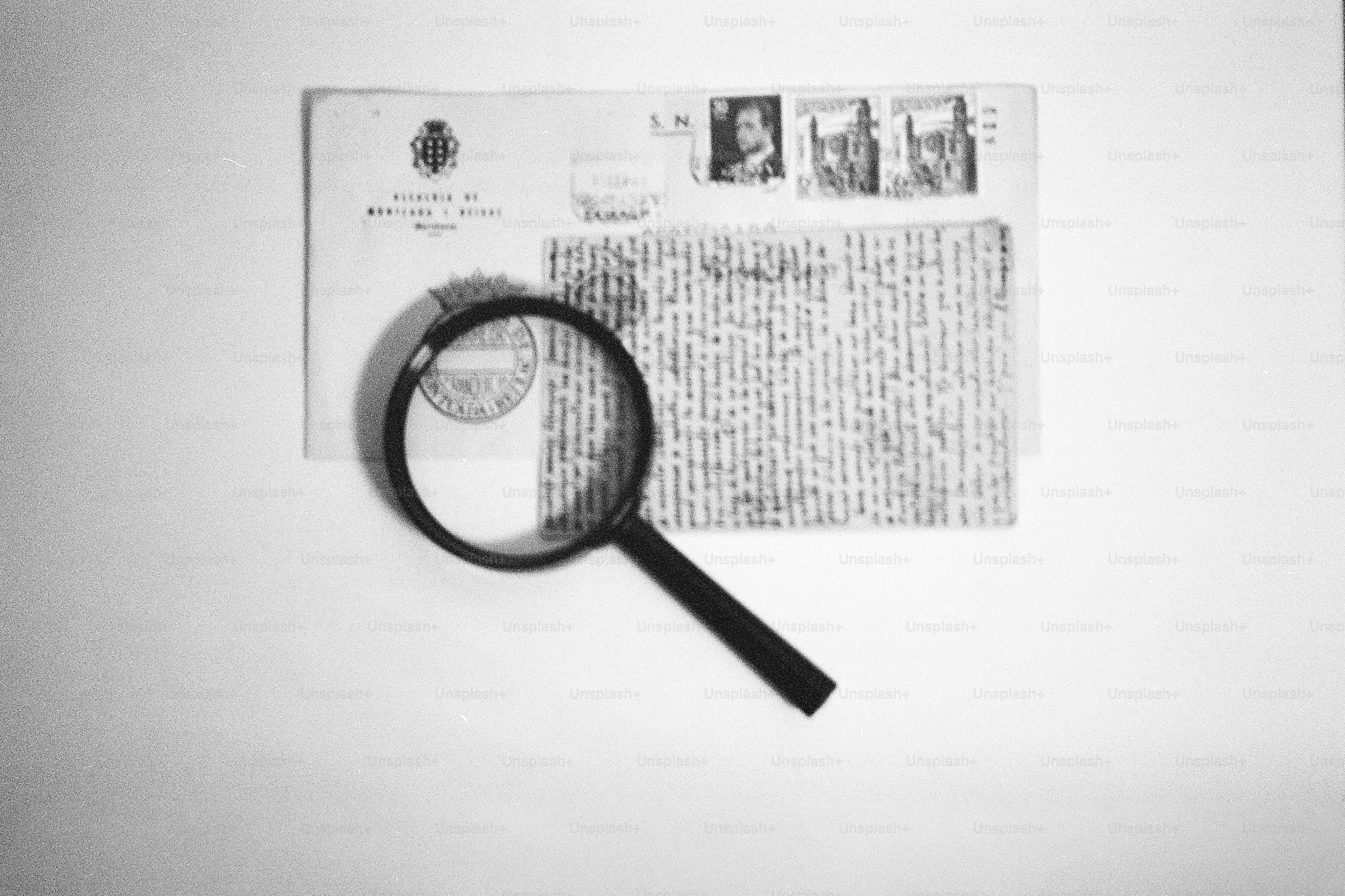 Magnifying glass over an envelope with stamps.