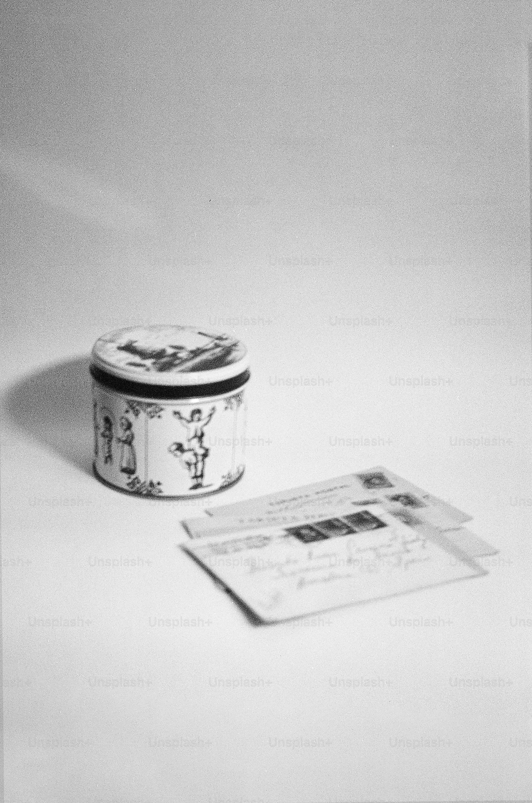 A vintage tin with letters on a white background