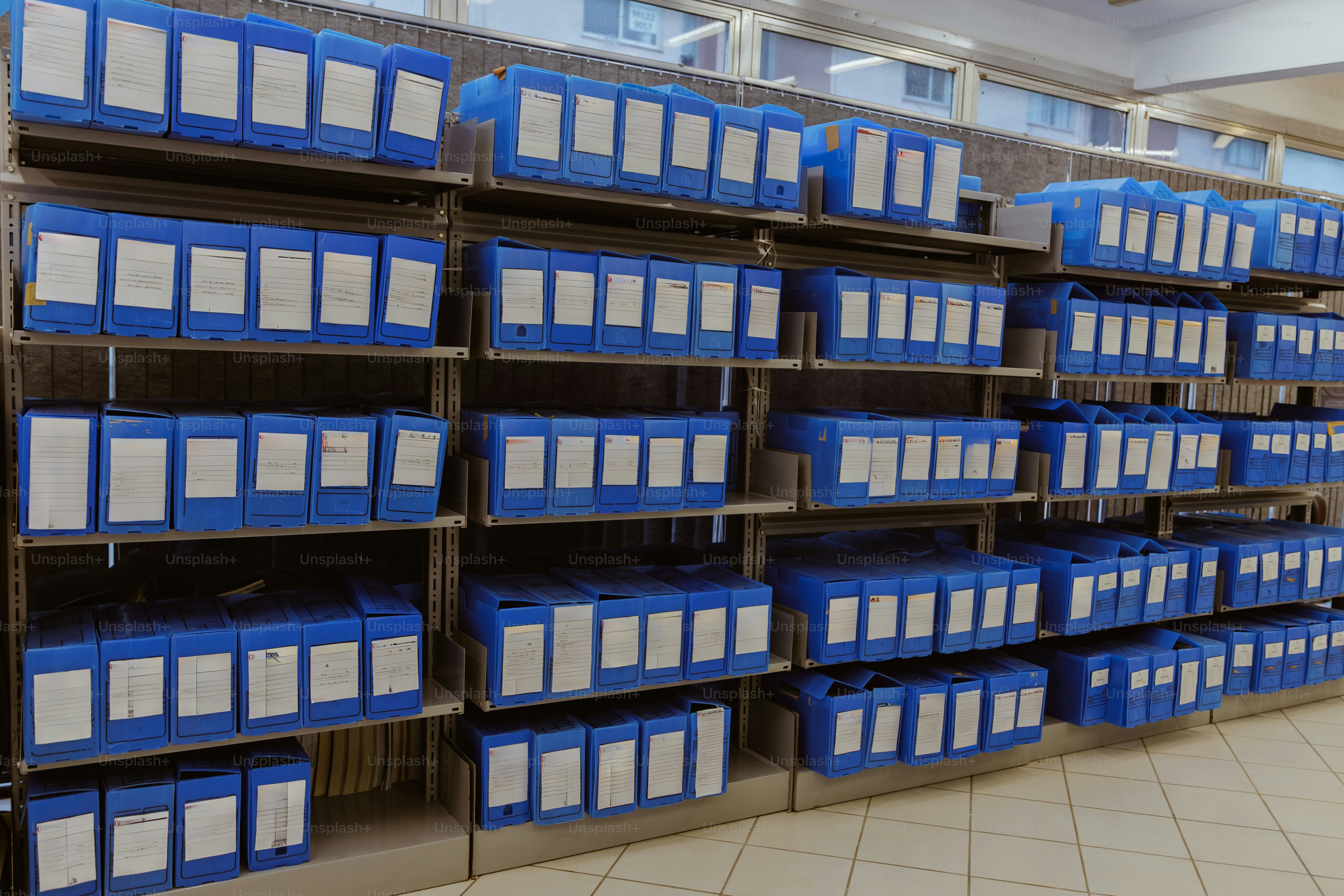 Rows of blue storage containers on shelves