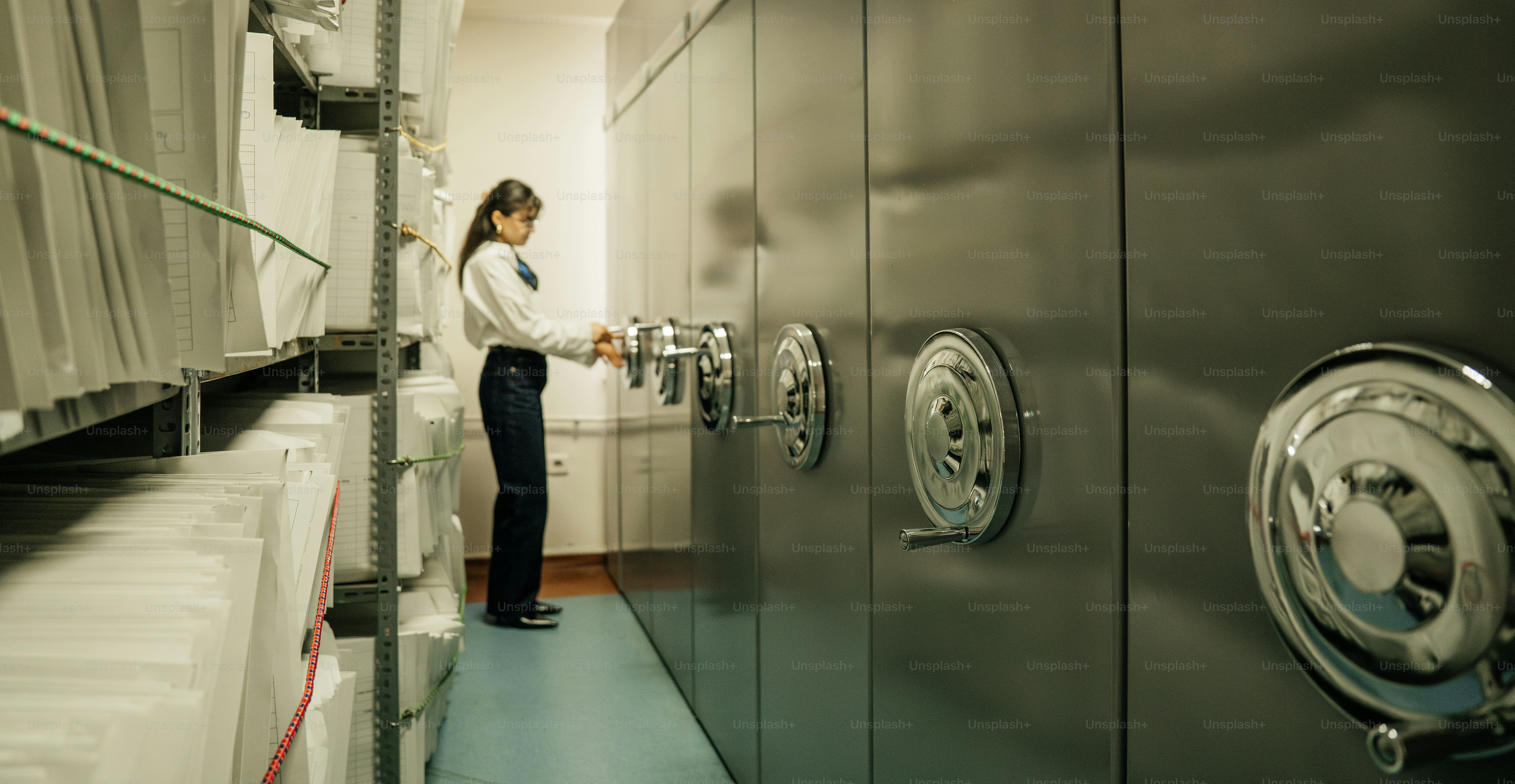 Woman opening a bank vault door