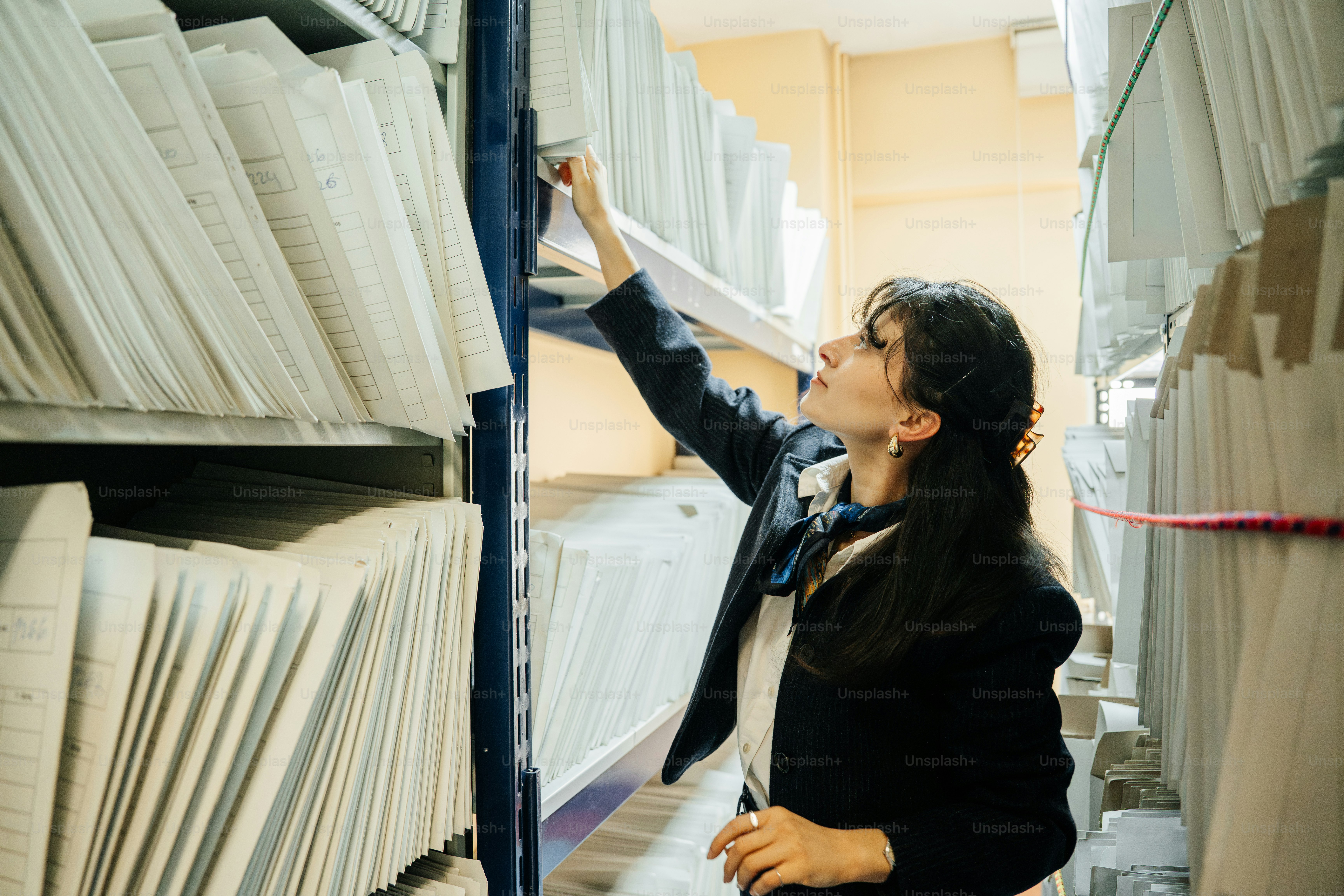 Woman reaching for file in archive photo – Business Image on Unsplash