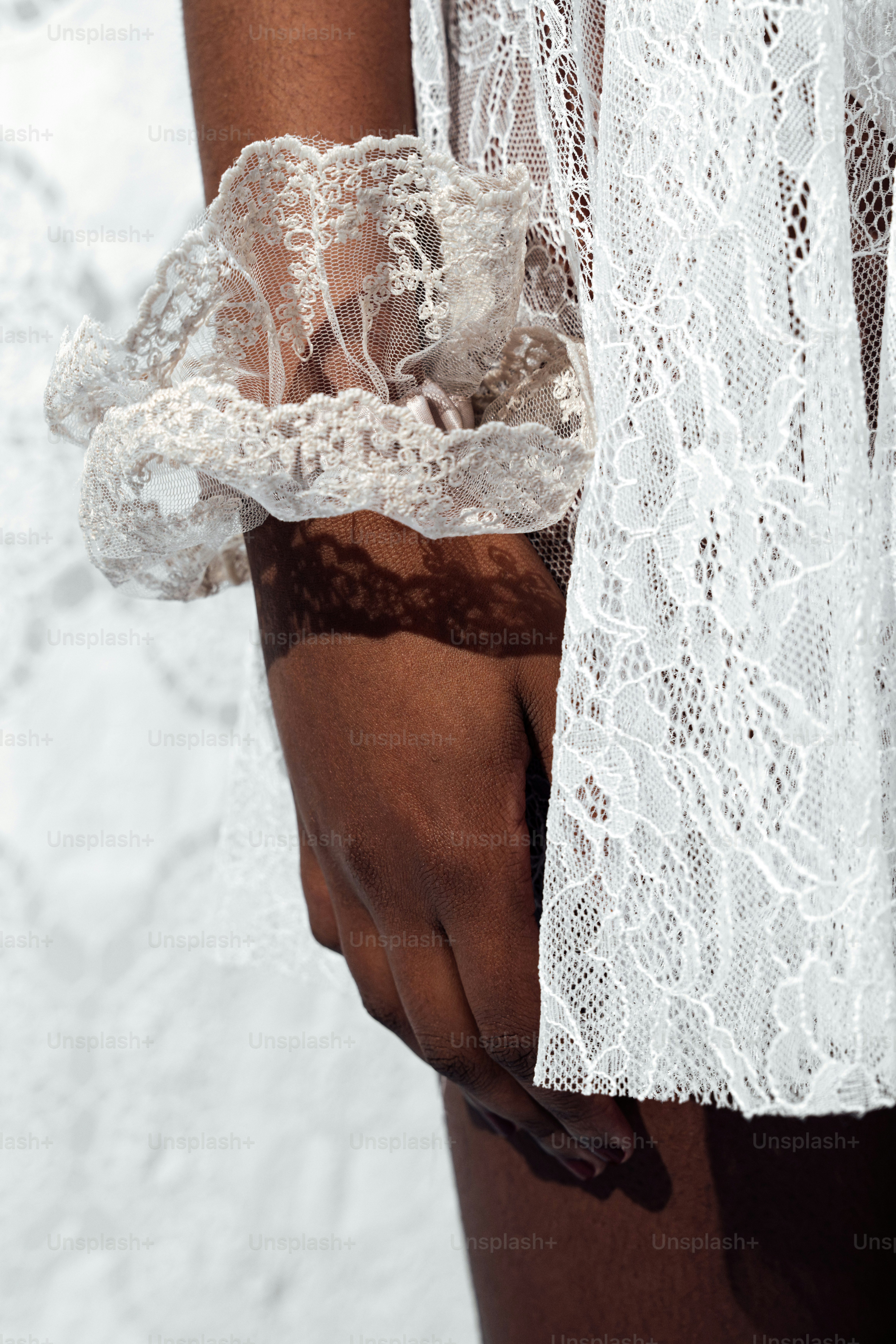 Close up of a woman's hand in white lace
