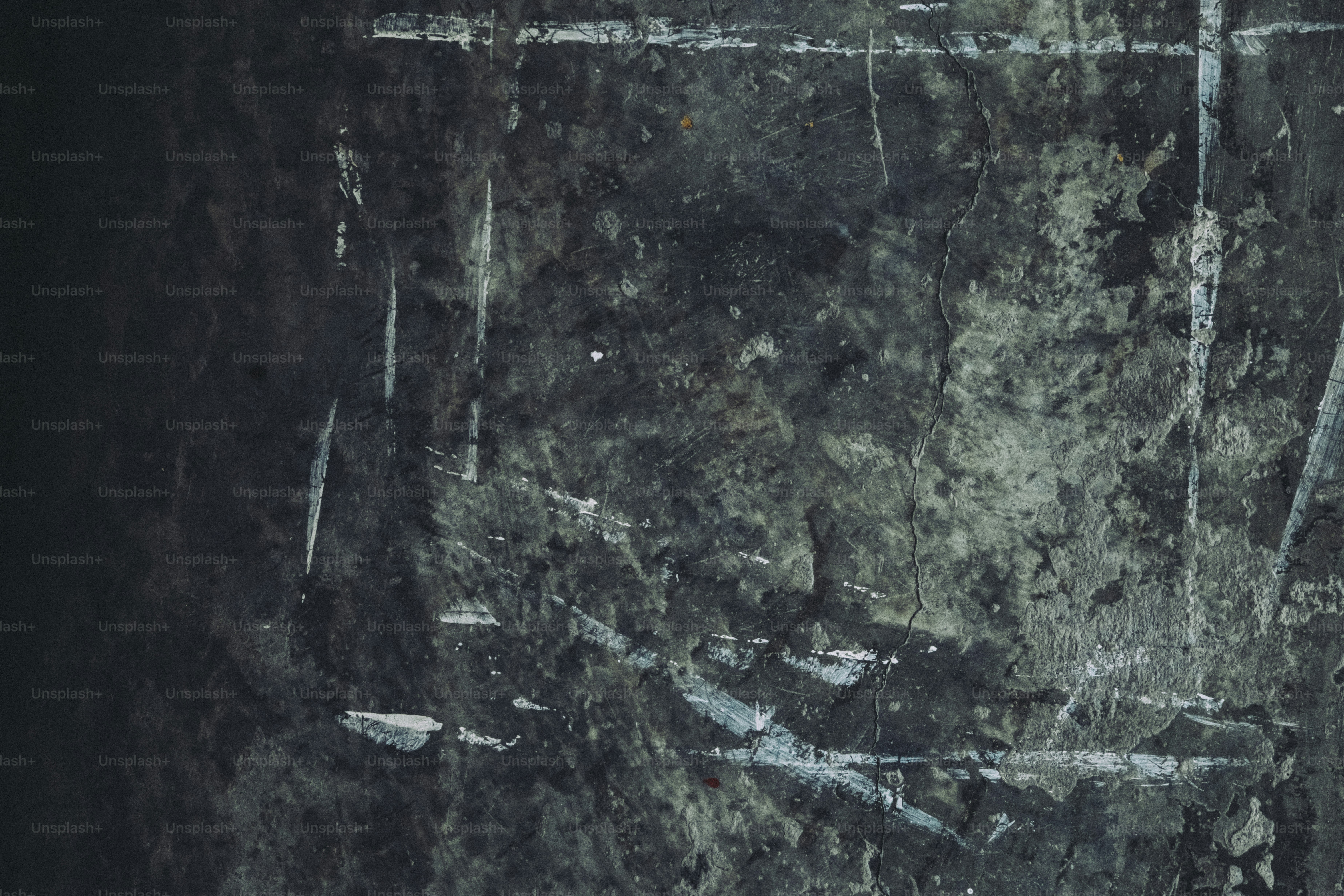 Dark textured surface with white scratches and smudges