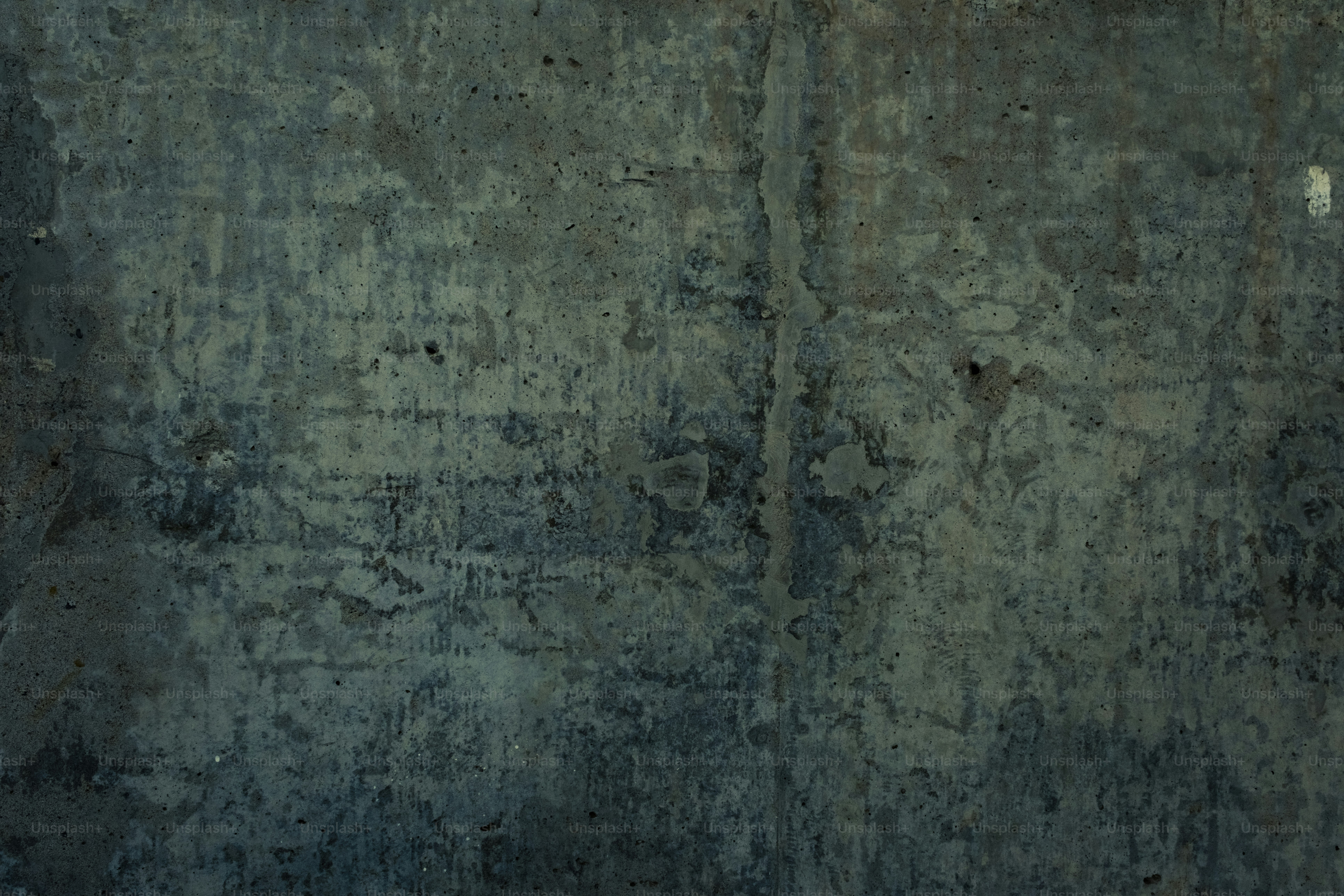 Textured concrete wall with dark blue and green hues
